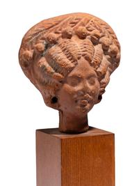 An Egyptian Terracotta Head of a Woman