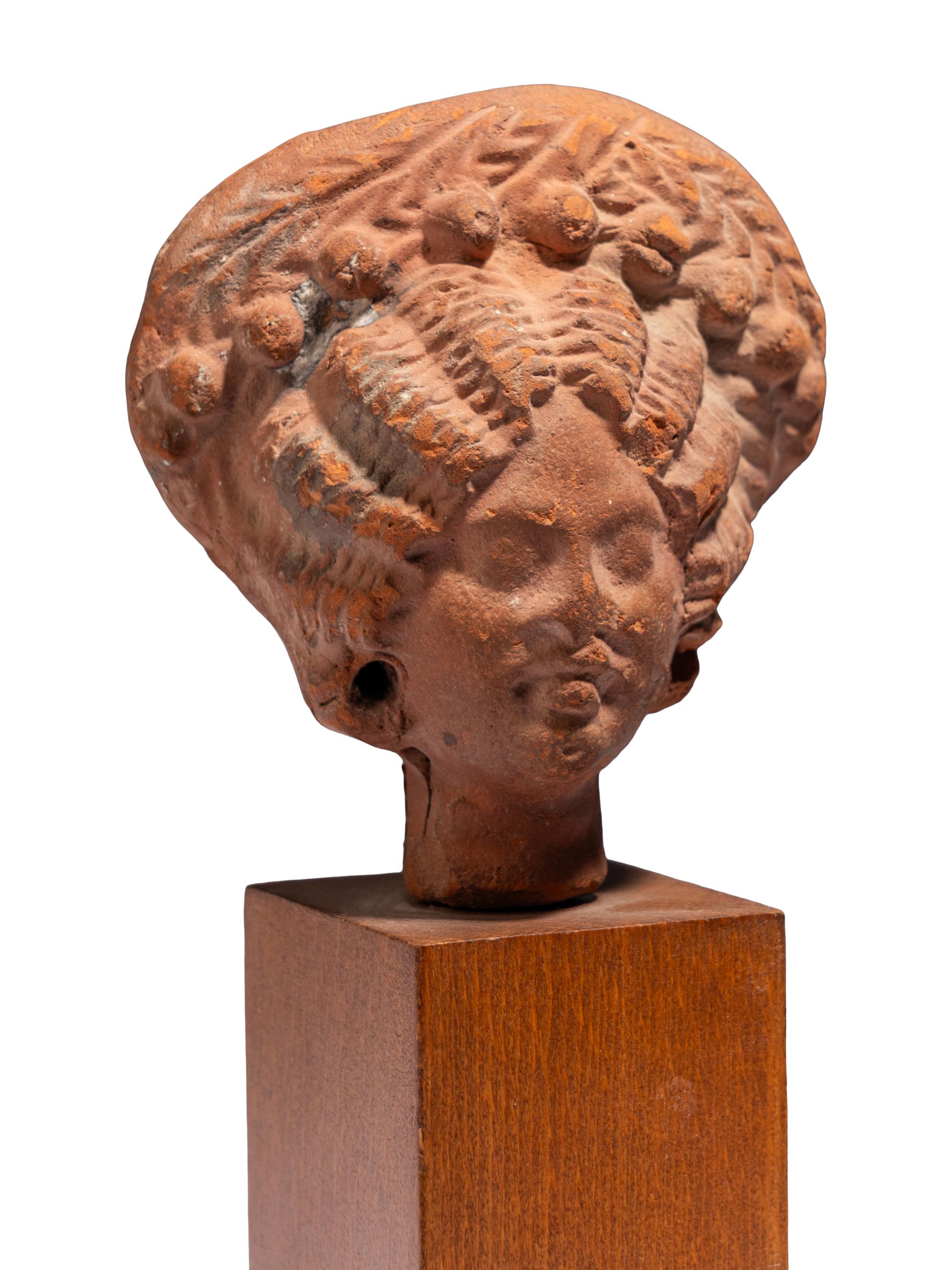 An Egyptian Terracotta Head of a Woman