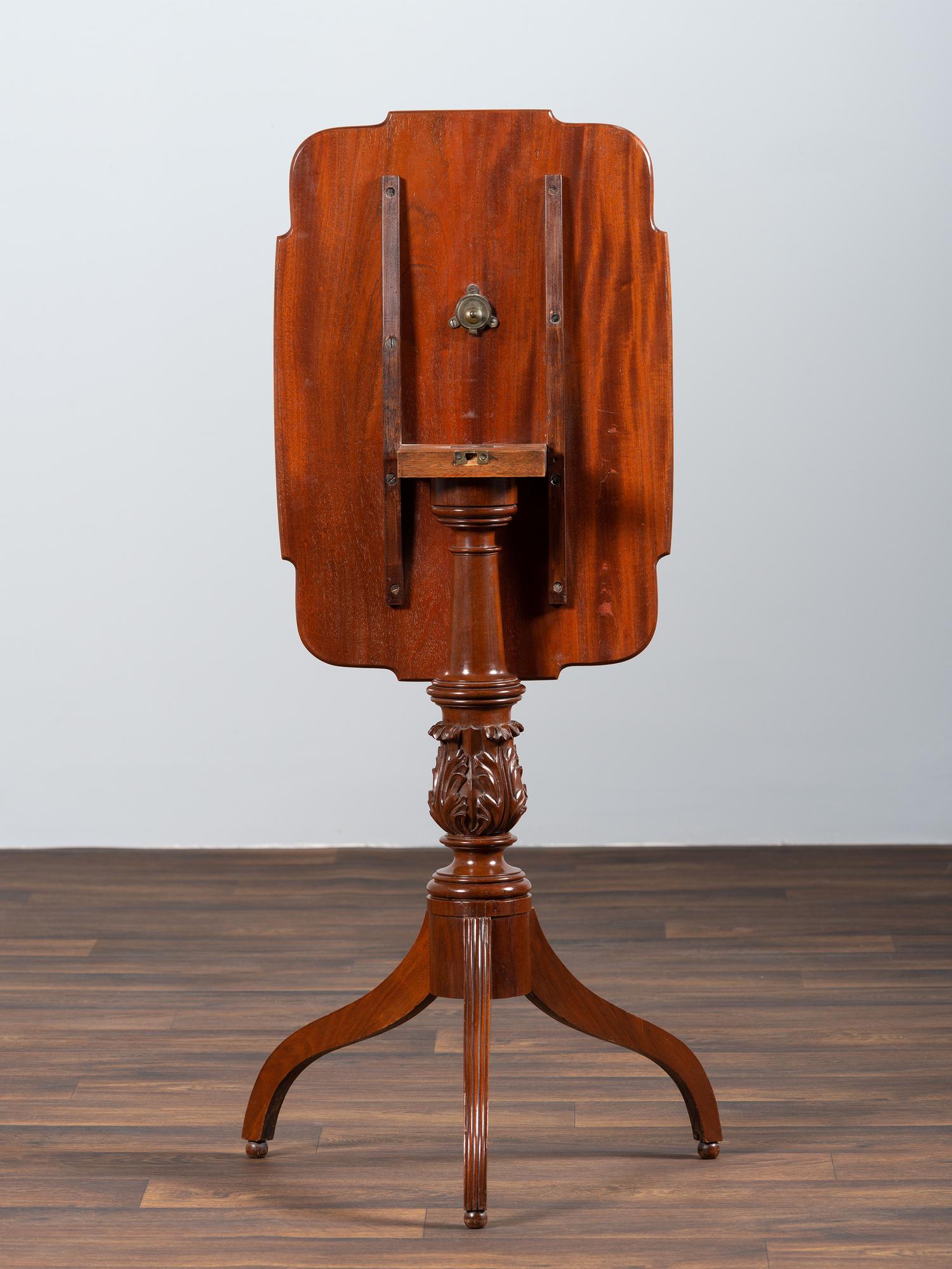 A Late Federal Carved and Figured Mahogany Shaped Top Candlestand