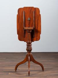 A Late Federal Carved and Figured Mahogany Shaped Top Candlestand