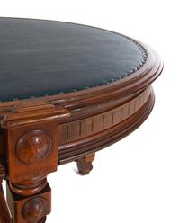 An Aesthetic Movement Leather Inset Carved Walnut Board Table