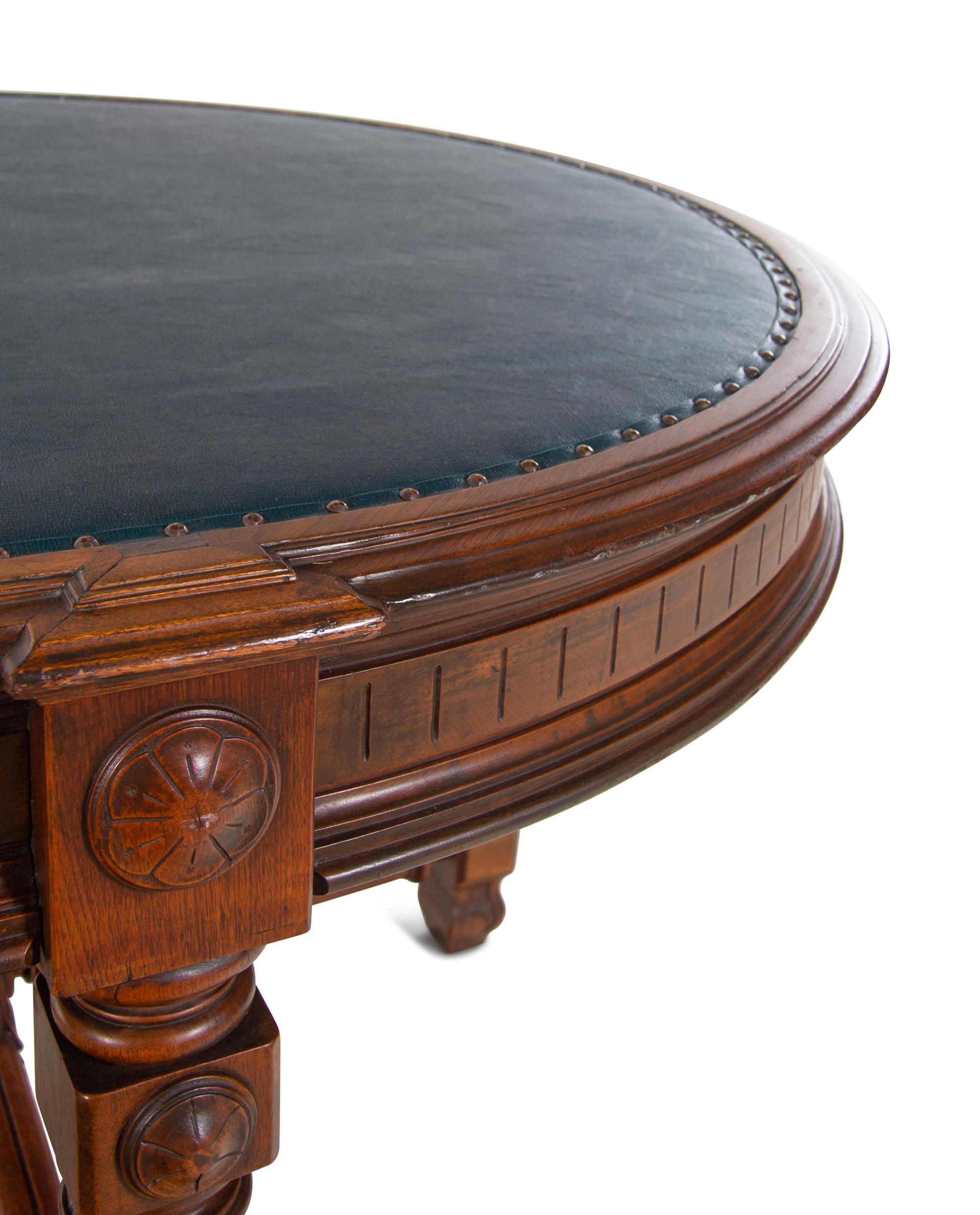 An Aesthetic Movement Leather Inset Carved Walnut Board Table