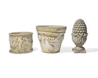 A group of three cast stone and resin garden pots and pineapple finial, 20th century