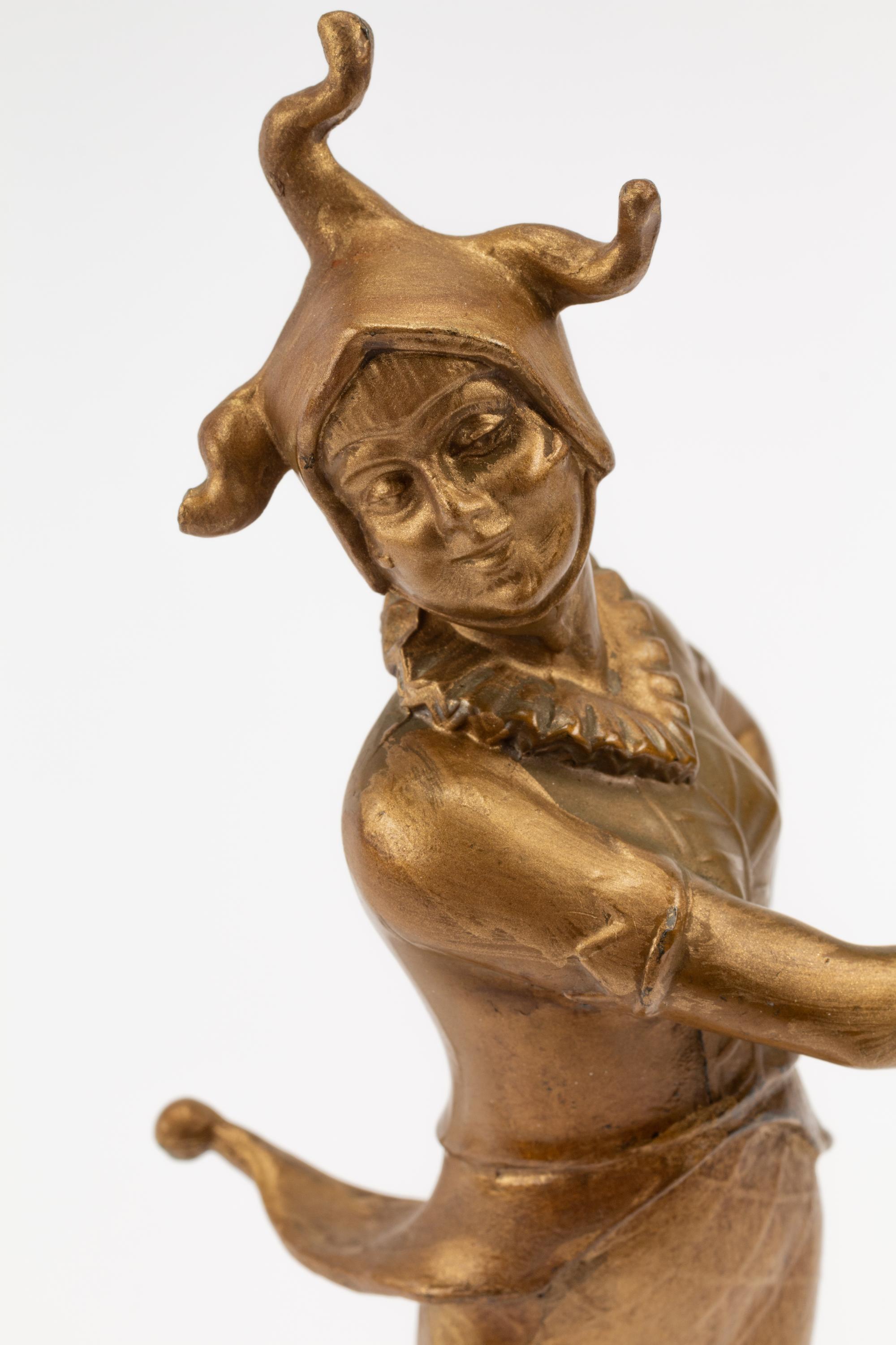 A French Gilt Bronze Figure of a Harlequin on an Onyx Base