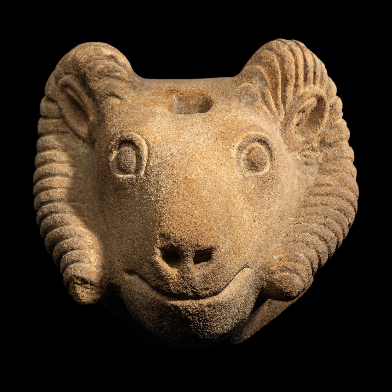 A Romano-Egyptian Style Sandstone Head of a Ram