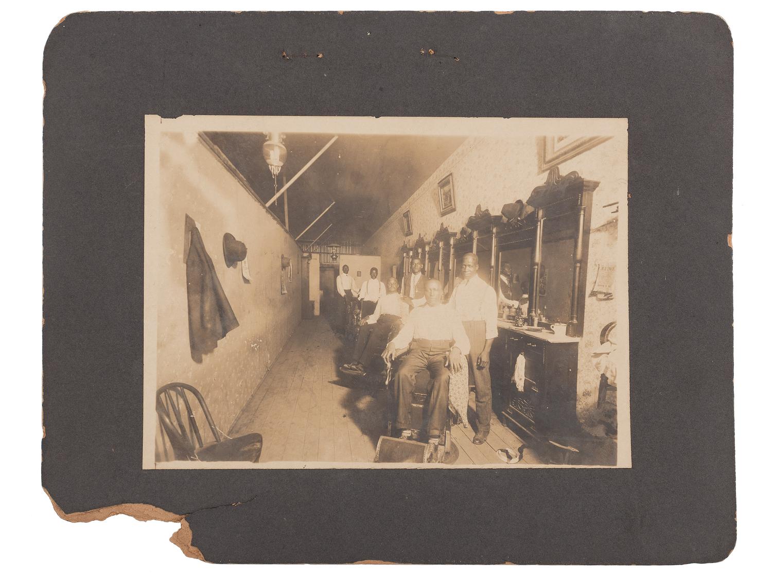 [EARLY PHOTOGRAPHY]. A group of 2 photographs of African American barbershops. Ca early 1900s.