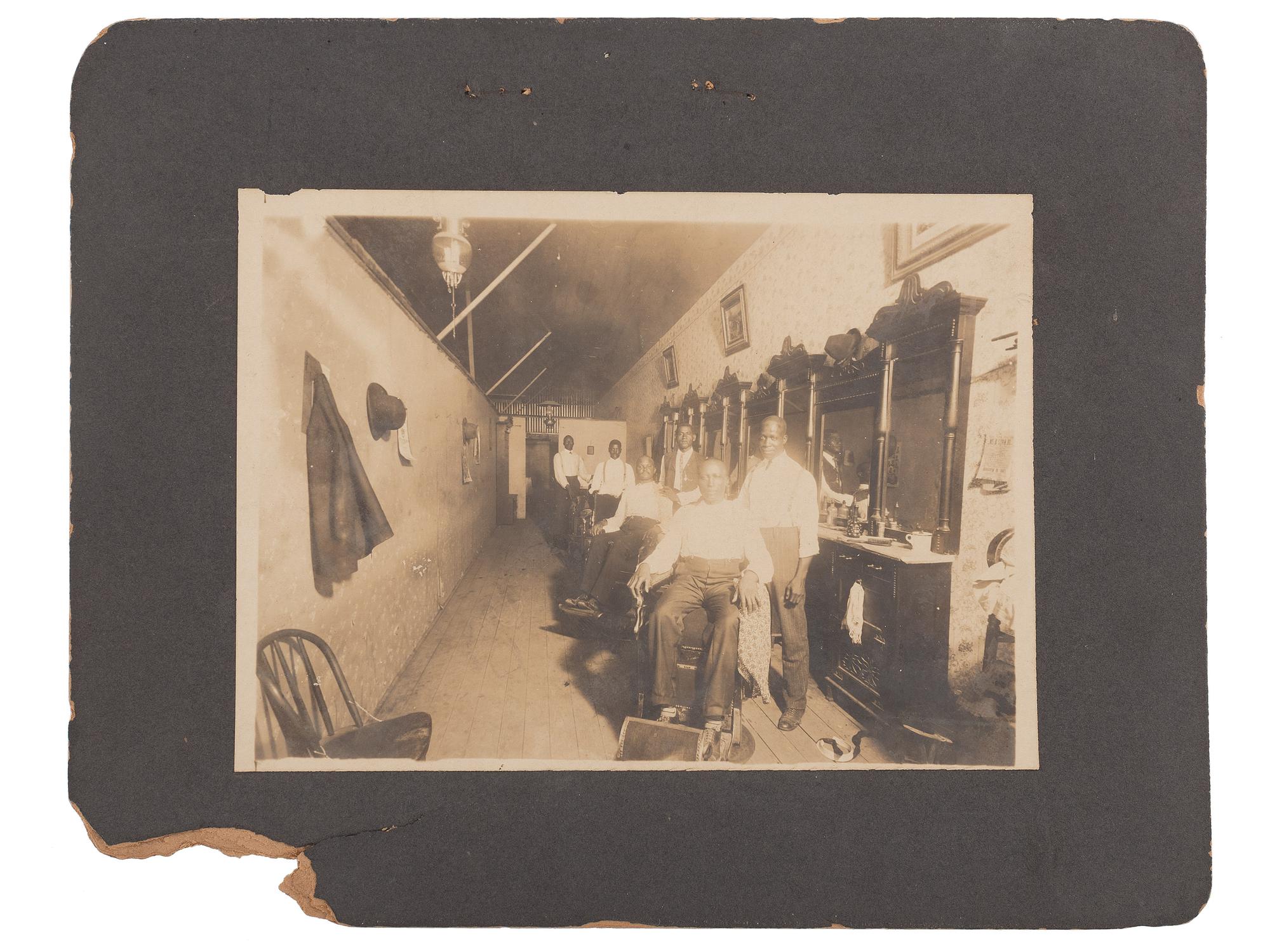 [EARLY PHOTOGRAPHY]. A group of 2 photographs of African American barbershops. Ca early 1900s.