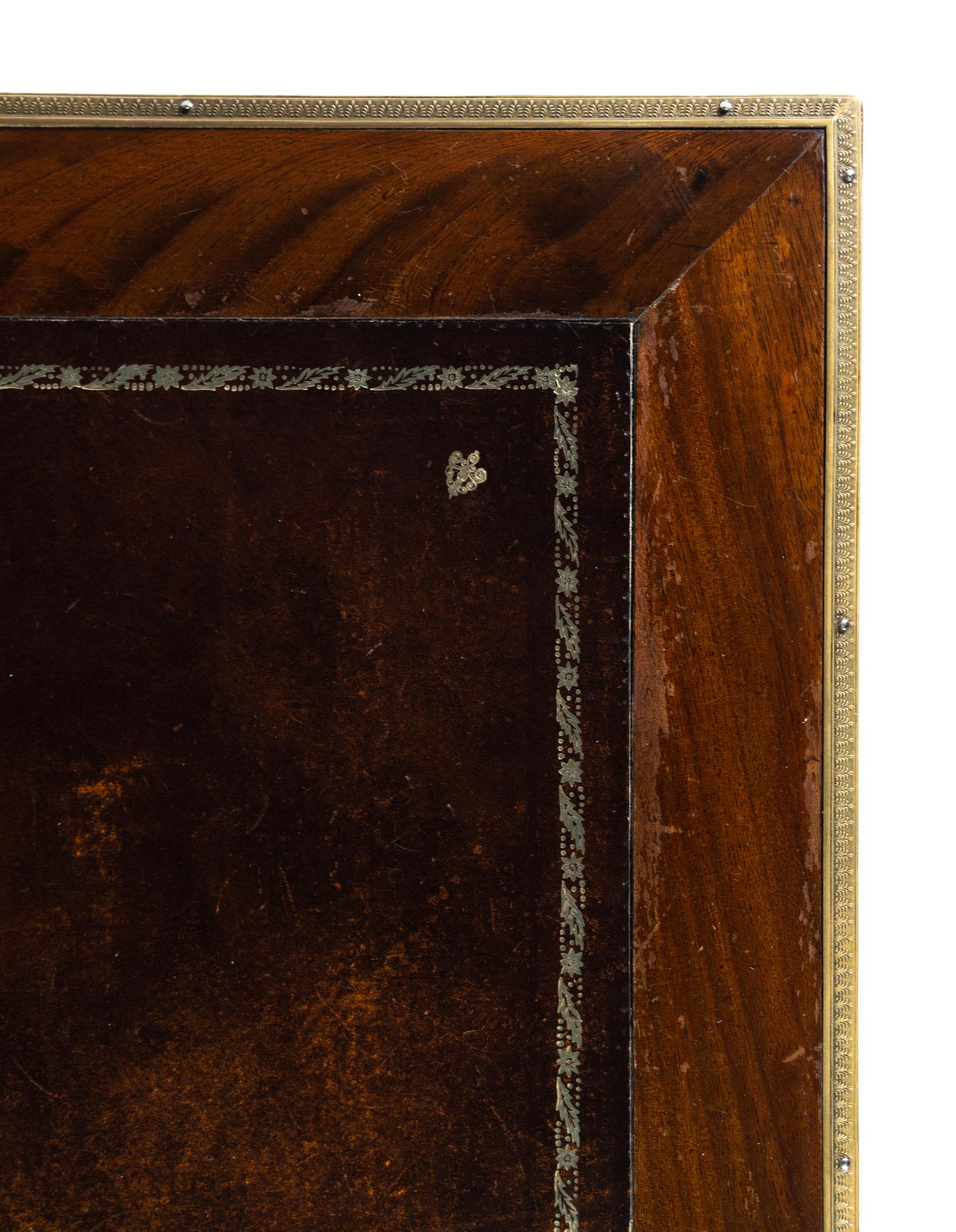 An Empire Style Gilt Metal Mounted Mahogany Bureau Plat and an Associated Armchair
