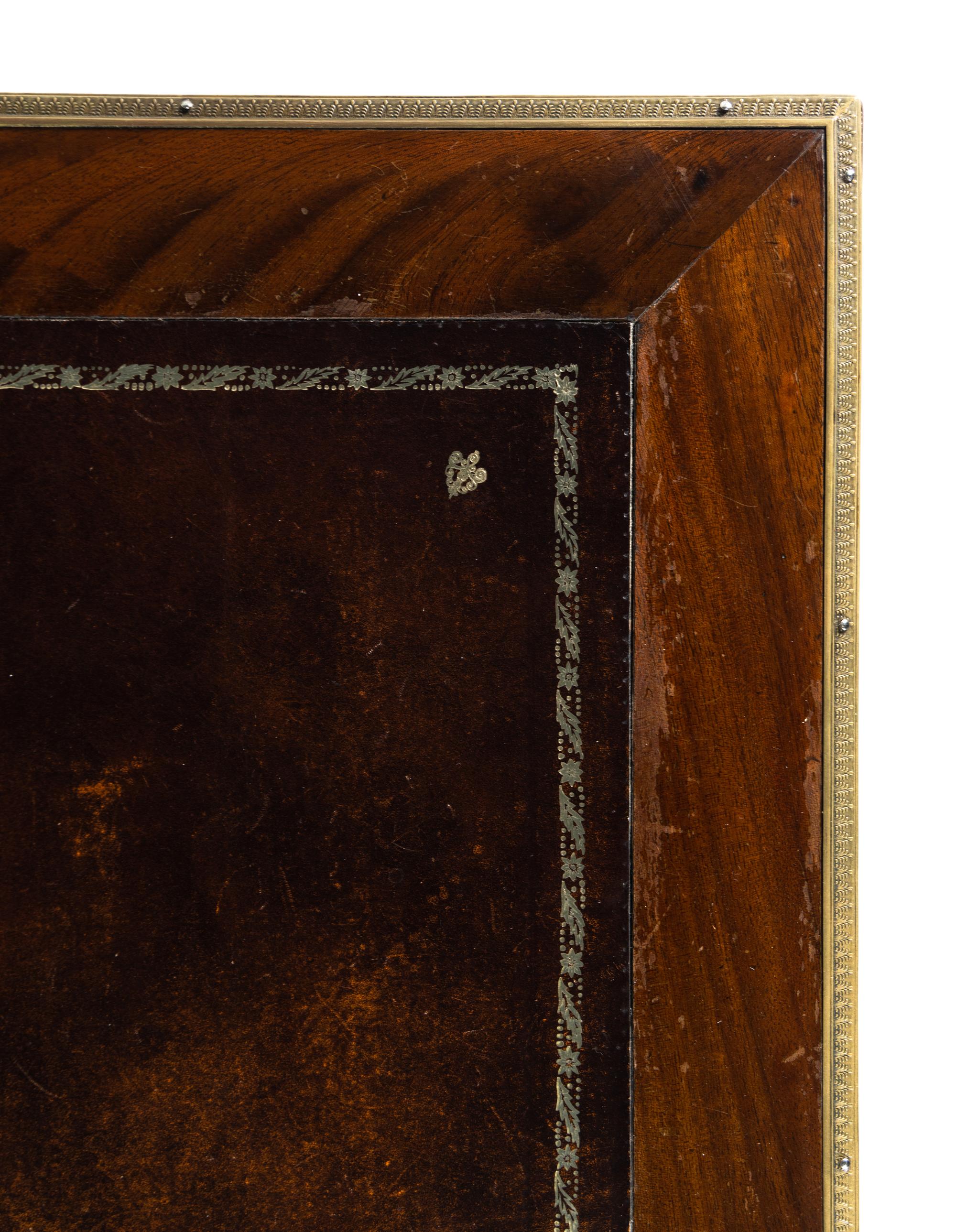 An Empire Style Gilt Metal Mounted Mahogany Bureau Plat and an Associated Armchair