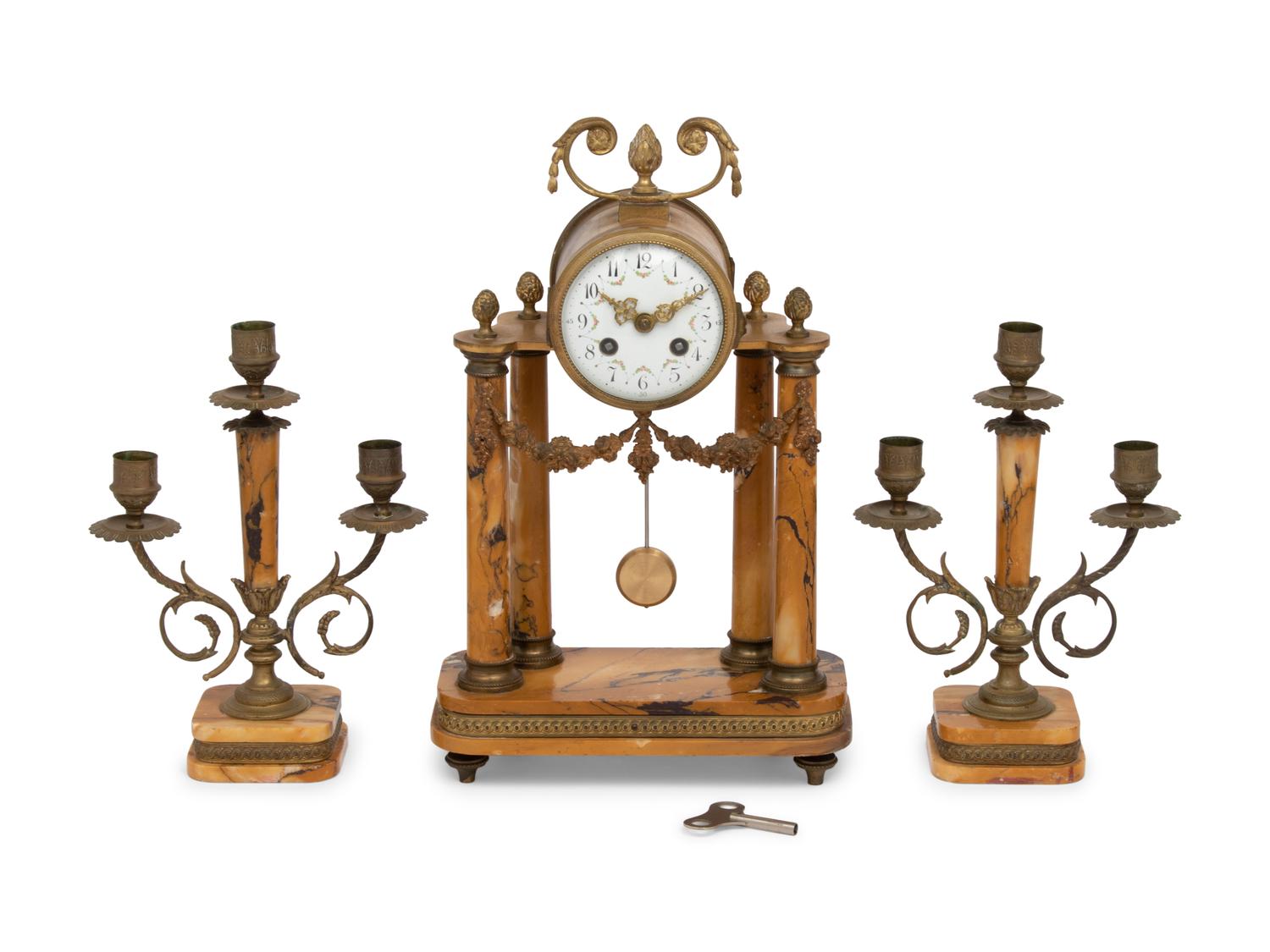 A French Gilt Metal and Siena Marble Three-Piece Clock Garniture