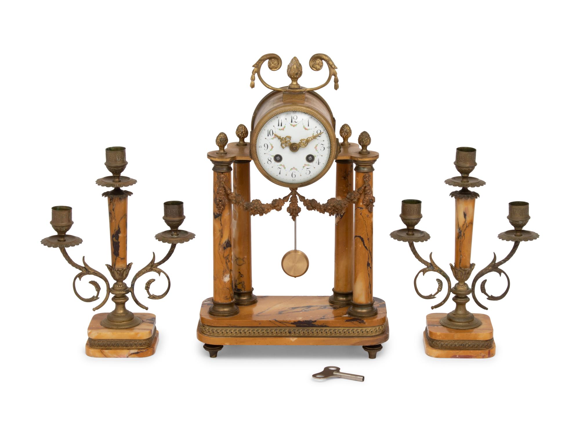 A French Gilt Metal and Siena Marble Three-Piece Clock Garniture