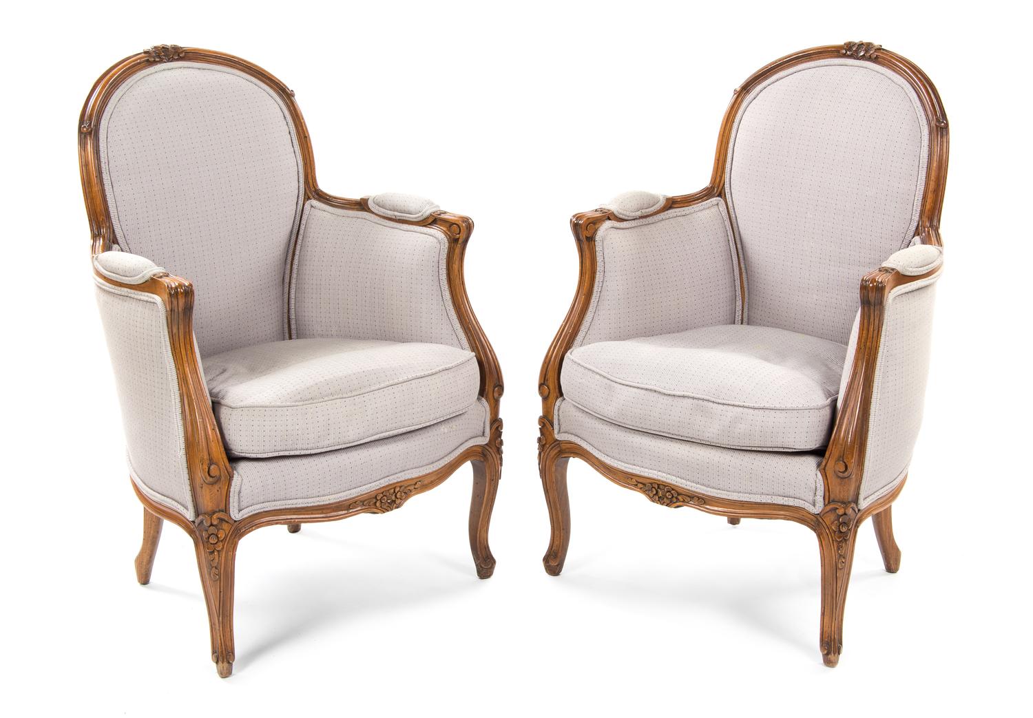 A Pair of Louis XV Style Walnut Bergeres, Height 34 inches.