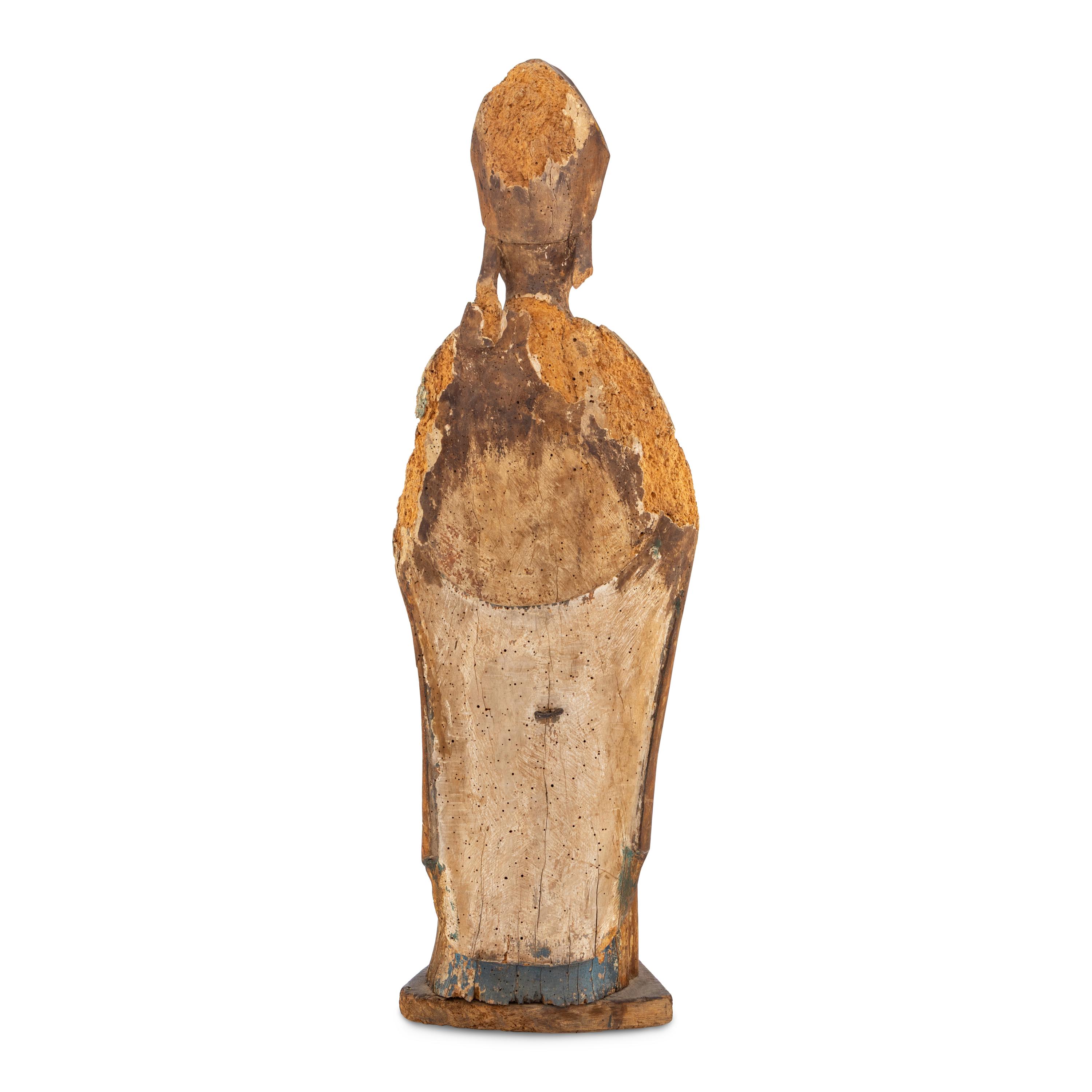 A Carved Walnut Figure of a Bishop
