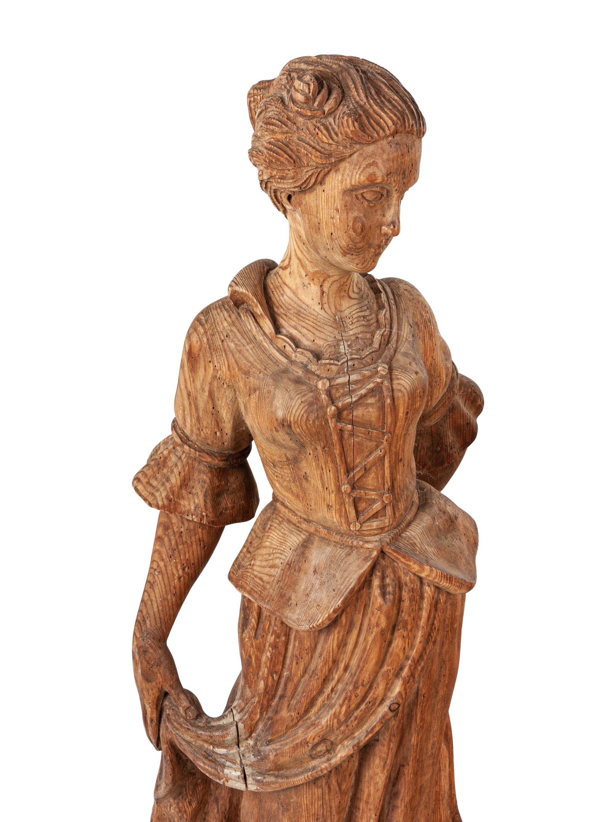 A Pair of Continental Carved Pine Figures
