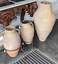 A Suite of Three Persian Terracotta Olive Oil Storage Jars Height of tallest 42 inches.