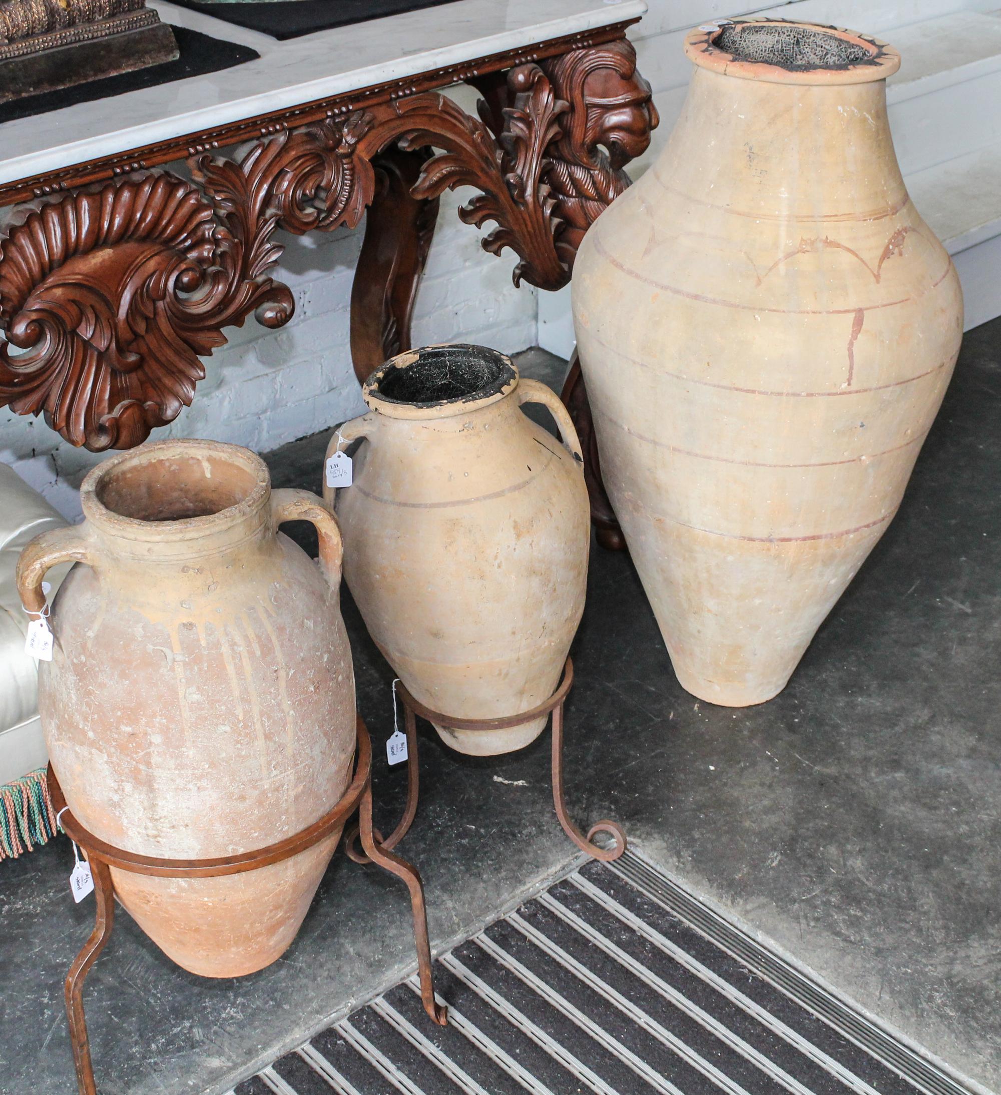 A Suite of Three Persian Terracotta Olive Oil Storage Jars Height of tallest 42 inches.