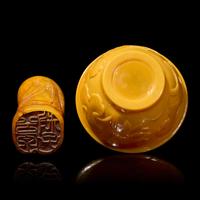 A Chinese Carved Stone "Luohan" Seal and a Yellow "Peking" Glass Bowl 壽山石雕羅漢和黃料花卉紋盌各一