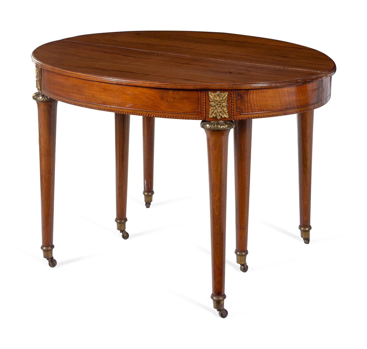 A Louis XVI Style Gilt Metal Mounted Walnut and Marquetry Extension Dining Table
