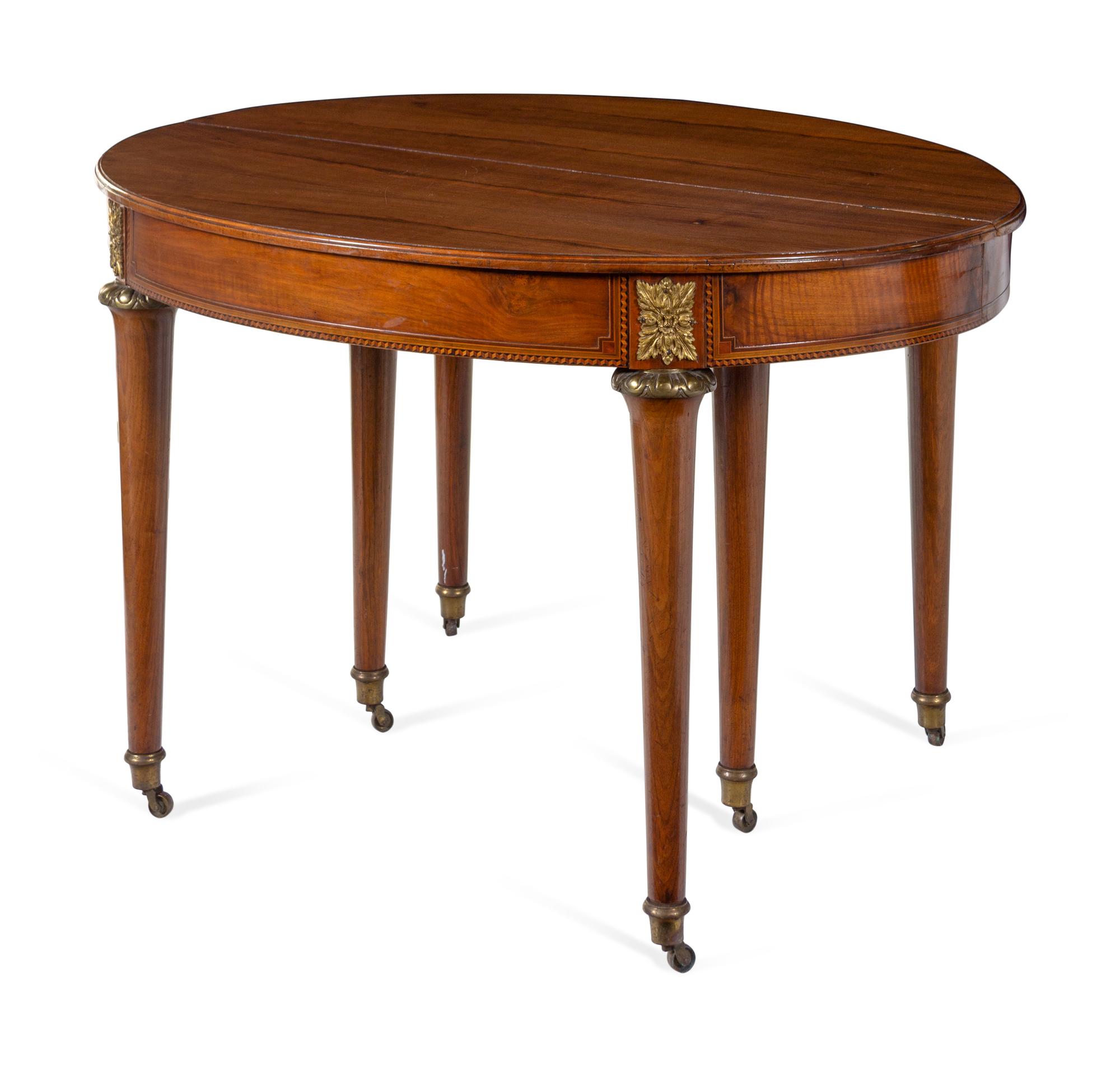 A Louis XVI Style Gilt Metal Mounted Walnut and Marquetry Extension Dining Table
