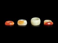 Four Chinese Jade and Hardstone Archer's Rings