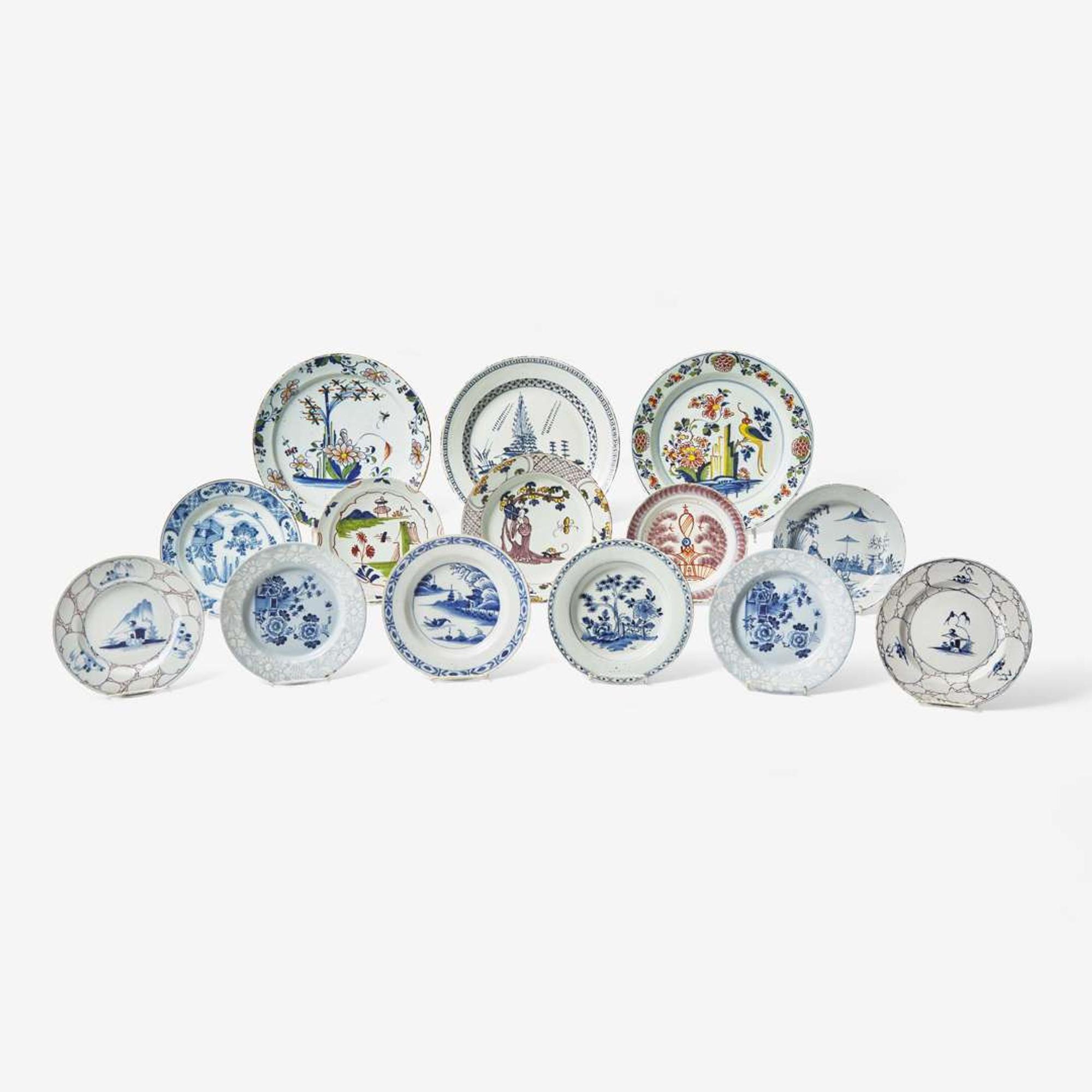 A collection of fourteen English Delft or tin-glazed earthenware plates 18th century