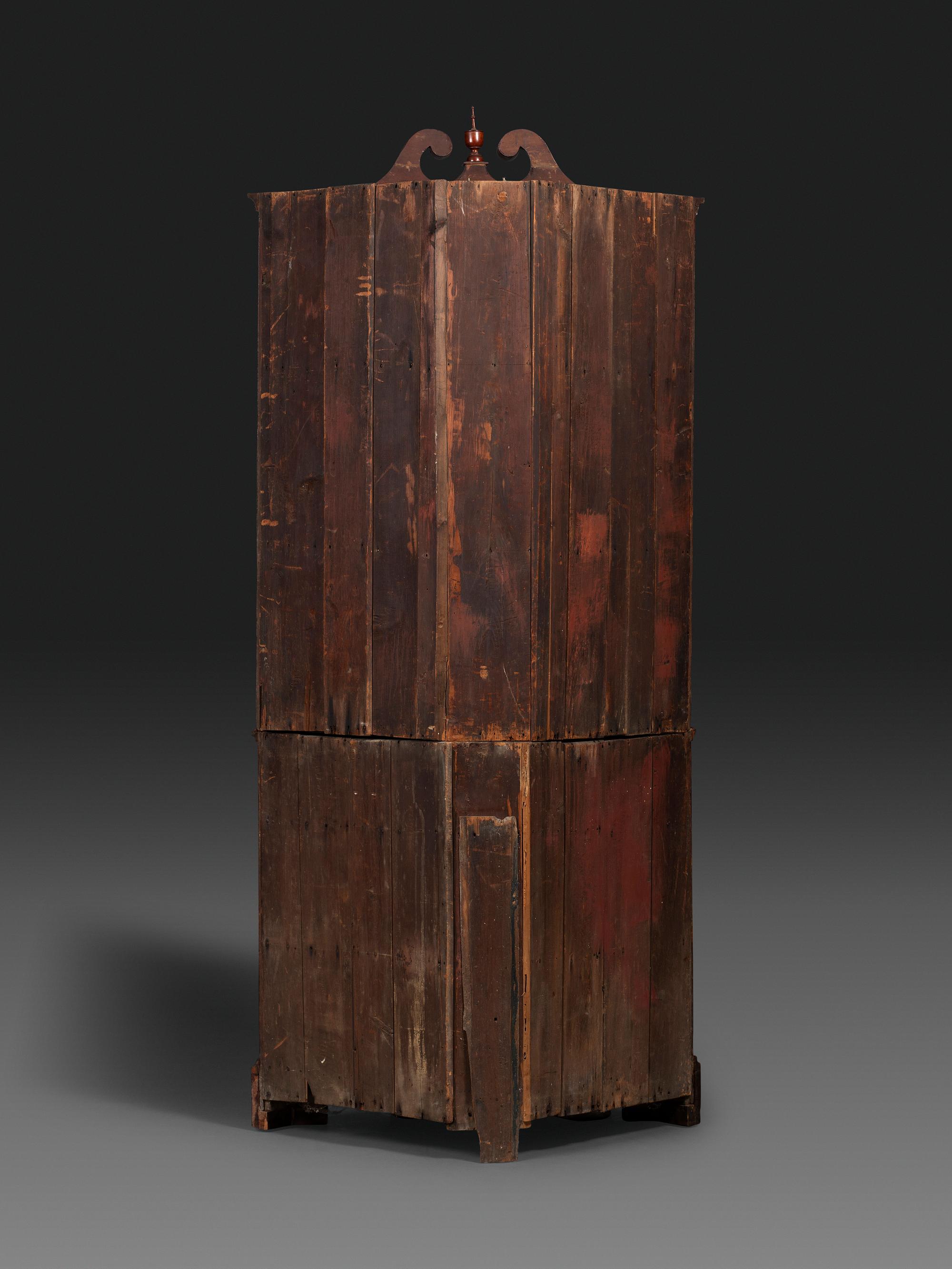 A Late Chippendale Carved Cherrywood Corner Cupboard