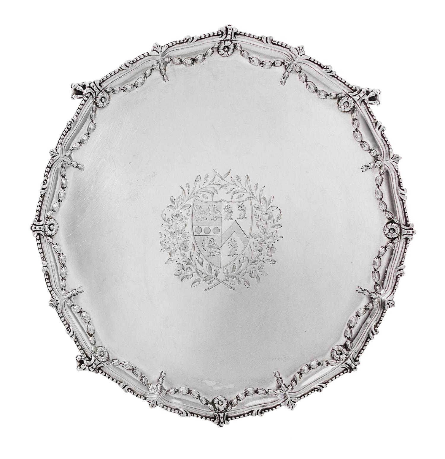 A George III Silver Salver, Maker's Mark I Pellet C, London 1771, shaped circular form with a beaded rim, the border chased with bellfl