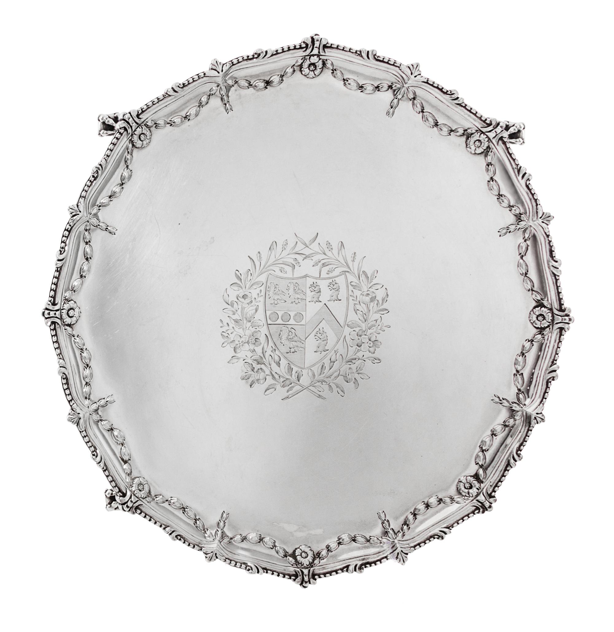 A George III Silver Salver, Maker's Mark I Pellet C, London 1771, shaped circular form with a beaded rim, the border chased with bellfl
