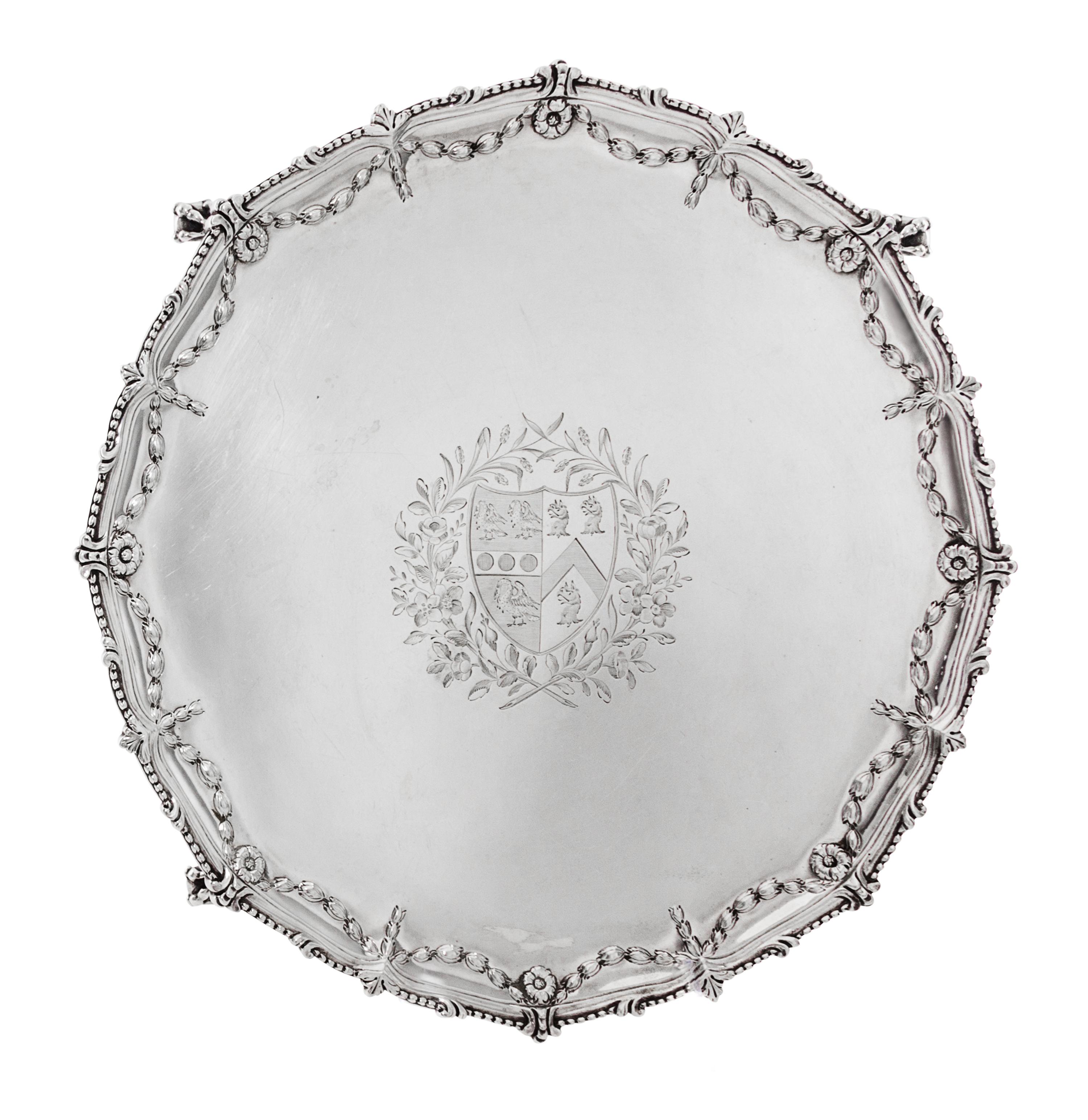 A George III Silver Salver, Maker's Mark I Pellet C, London 1771, shaped circular form with a beaded rim, the border chased with bellfl