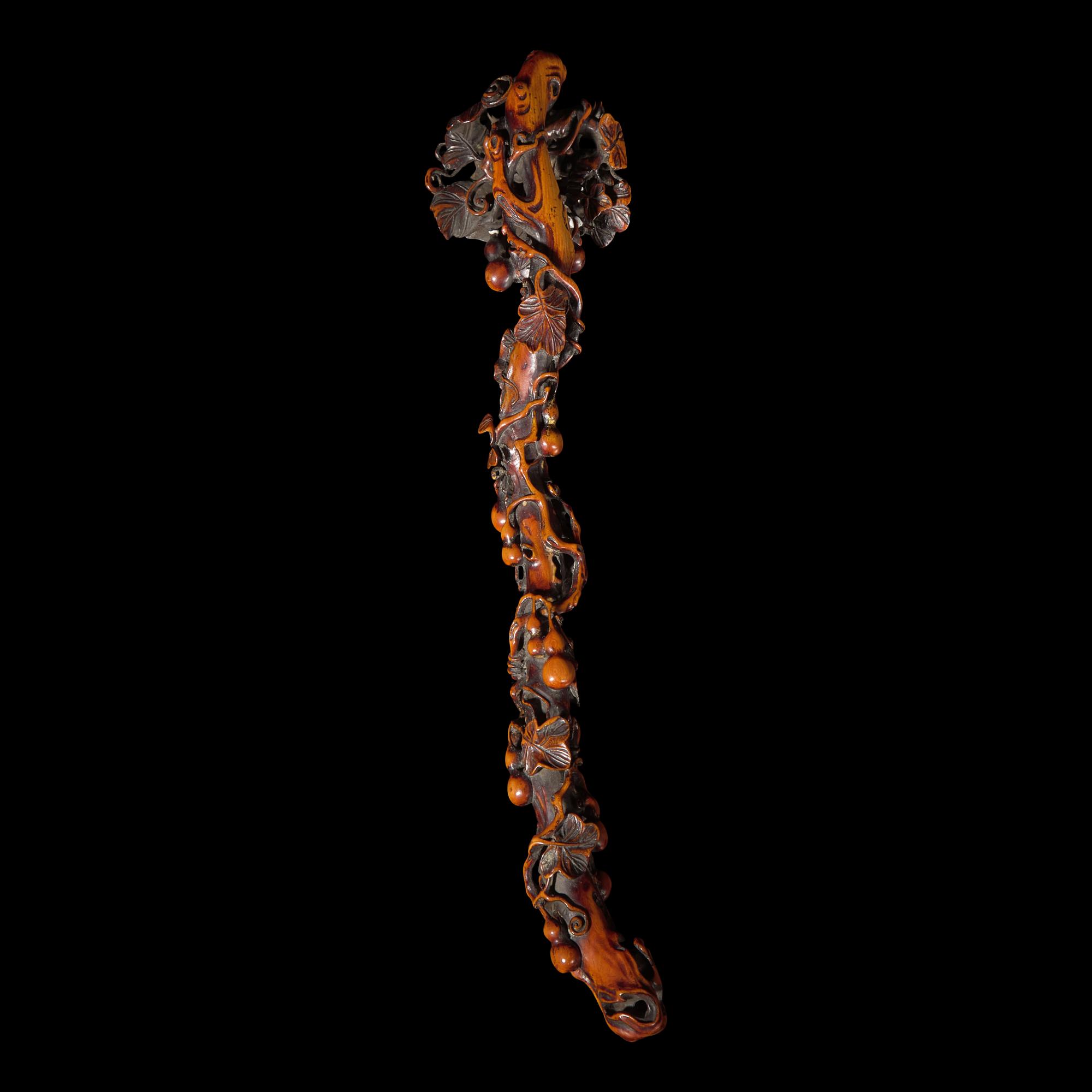 A Chinese Finely Carved Stained Bone Ruyi Scepter, Qing Dynasty — 清 木“福祿萬代”如意