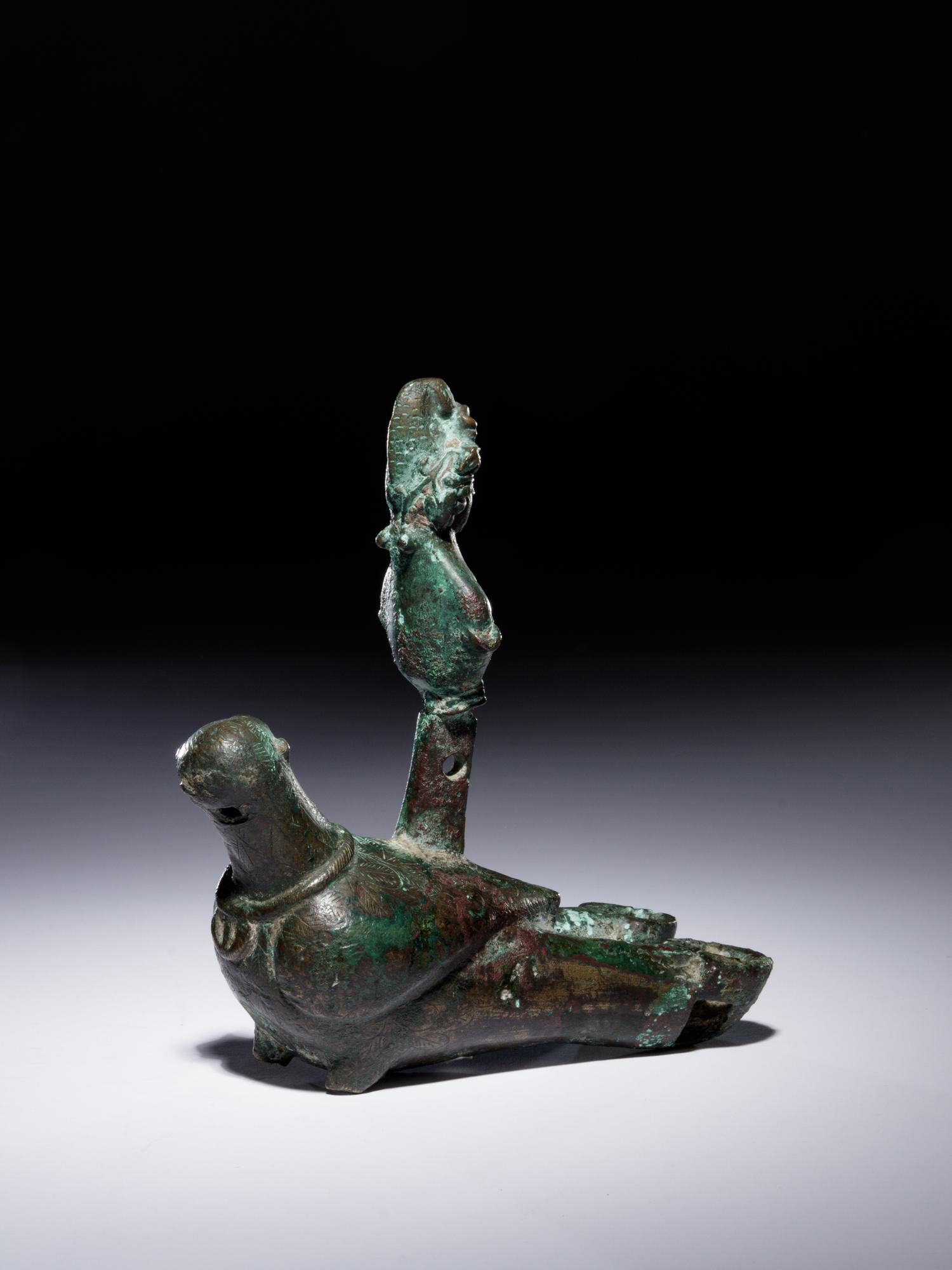 A Roman Bronze Oil Lamp in the Shape of a Dove with the Bust of a Goddess