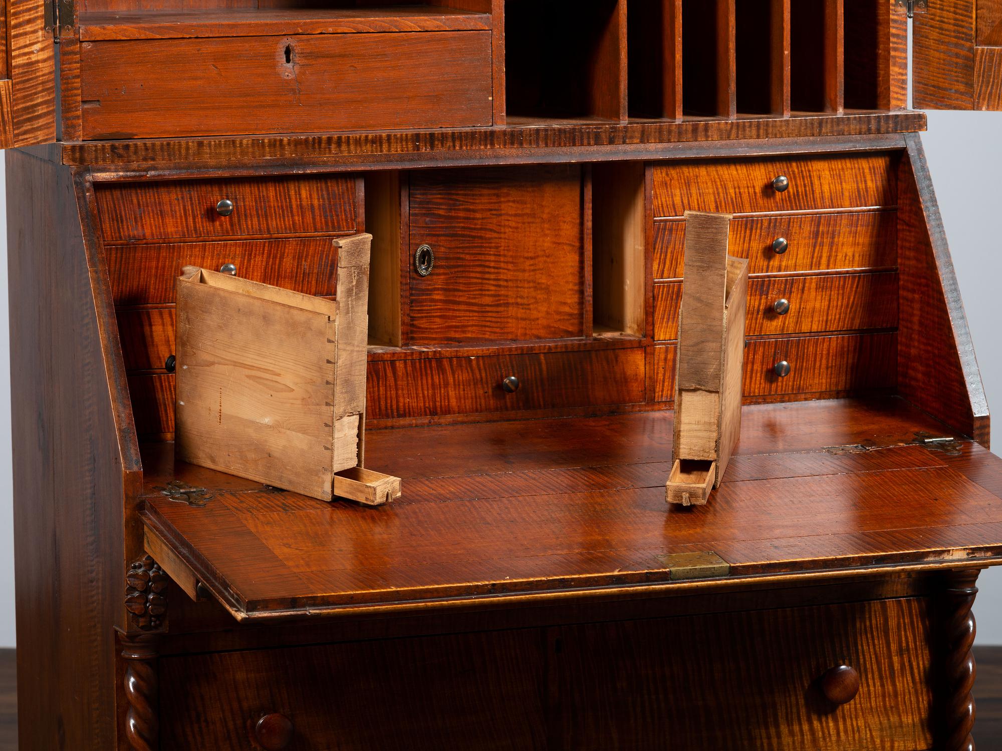 A Classical Style Carved and Highly Figured Tiger Maple Slant Front Desk