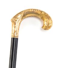 An American Chased Gold Handled Cane, Redlich & Co., Width of handle 4 3/4 x length overall 36 1/4 inches.