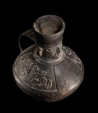 A Chimu Blackware Vessel with Human Face and Animal Motif