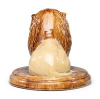 A Yellowware Recumbent Lion Figure