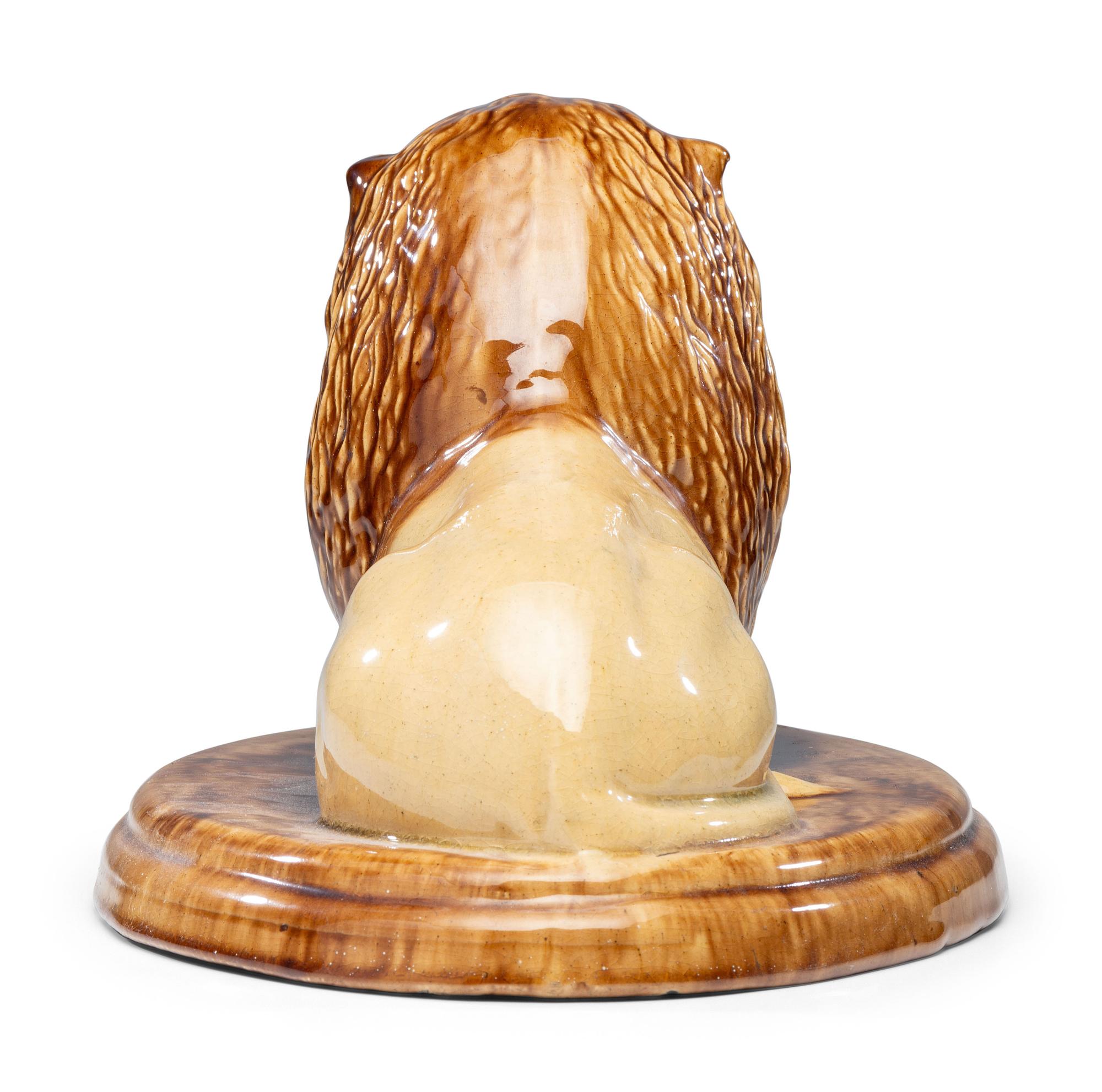 A Yellowware Recumbent Lion Figure