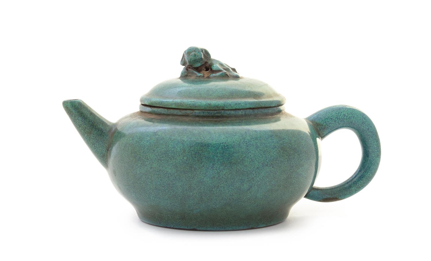 A Green Glazed Yixing Pottery Teapot Height 3 5/8 x width over handle 7 7/8 inches.