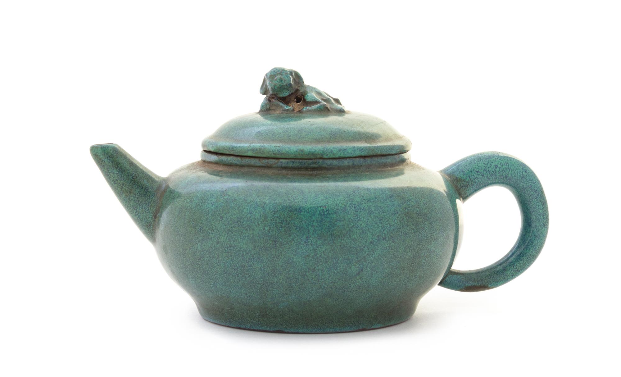 A Green Glazed Yixing Pottery Teapot Height 3 5/8 x width over handle 7 7/8 inches.