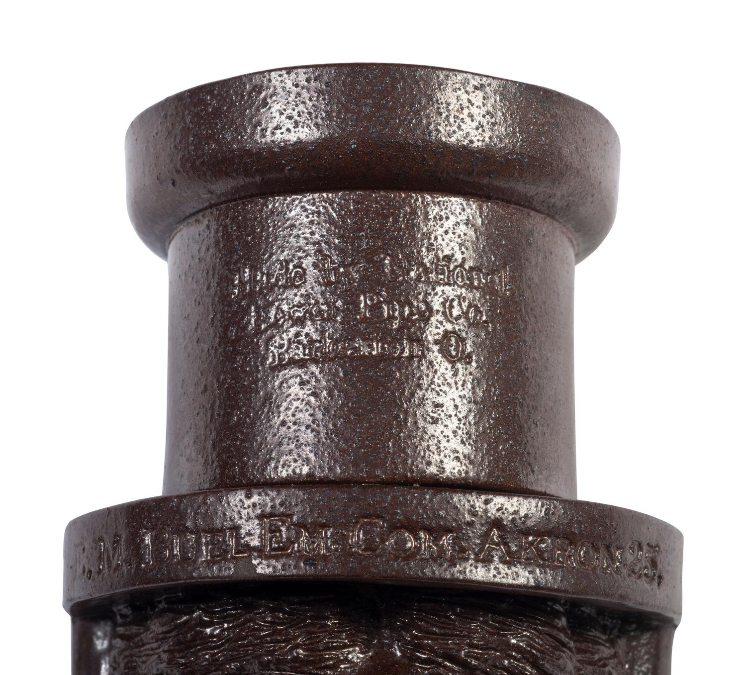 A Glazed Sewer Tile 'Liberty Head' Hanging Match Holder