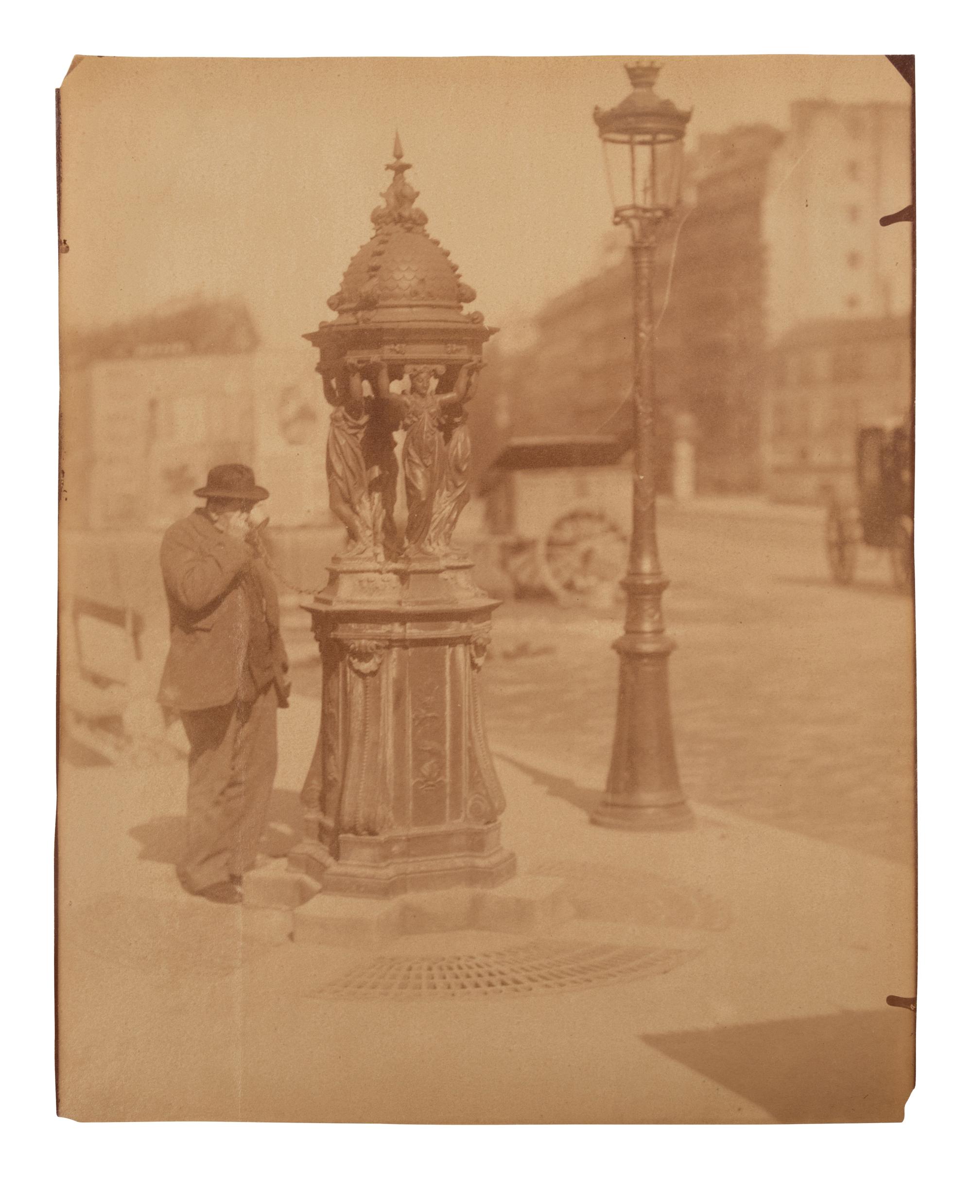 A group of four photographs ( Untitled [man at fountain], circa 1900s; Boutique empire, 14 rue de Grammont , 1903-1904; Hôtel de Neuville, rue Alphonse de Neuville, 1905-1906; Fontaine, faubourg Saint-Martin, 1912)