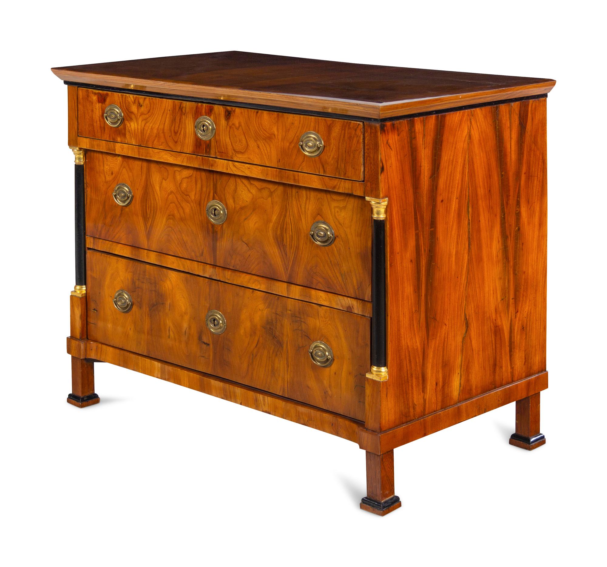 A Biedermeier Parcel Ebonized Walnut Commode
