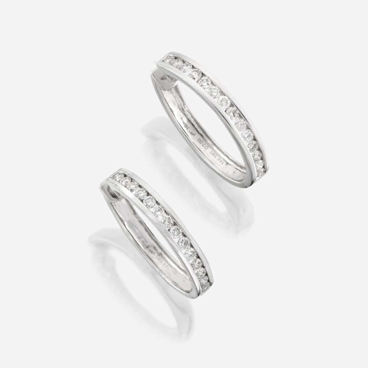 A pair of diamond and fourteen karat white gold earrings