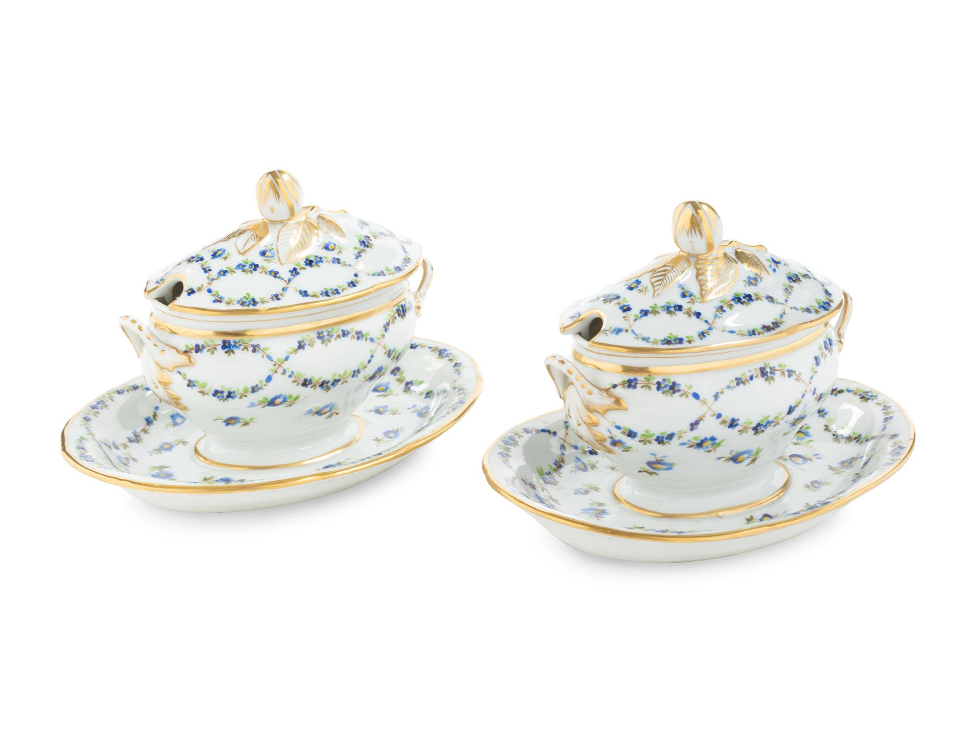 A Pair of English Porcelain Covered Sauce Tureens with Attached Underplates
