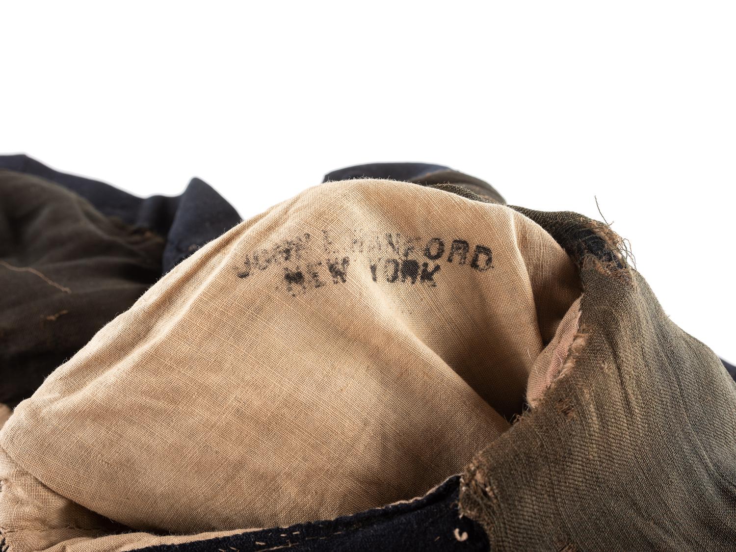 [CIVIL WAR]. A collection of items attributed to Thomas W. Johnson, Co. K, 4th Delaware Infantry, incl. frock coat, cap, belt rig, and cartridge box.