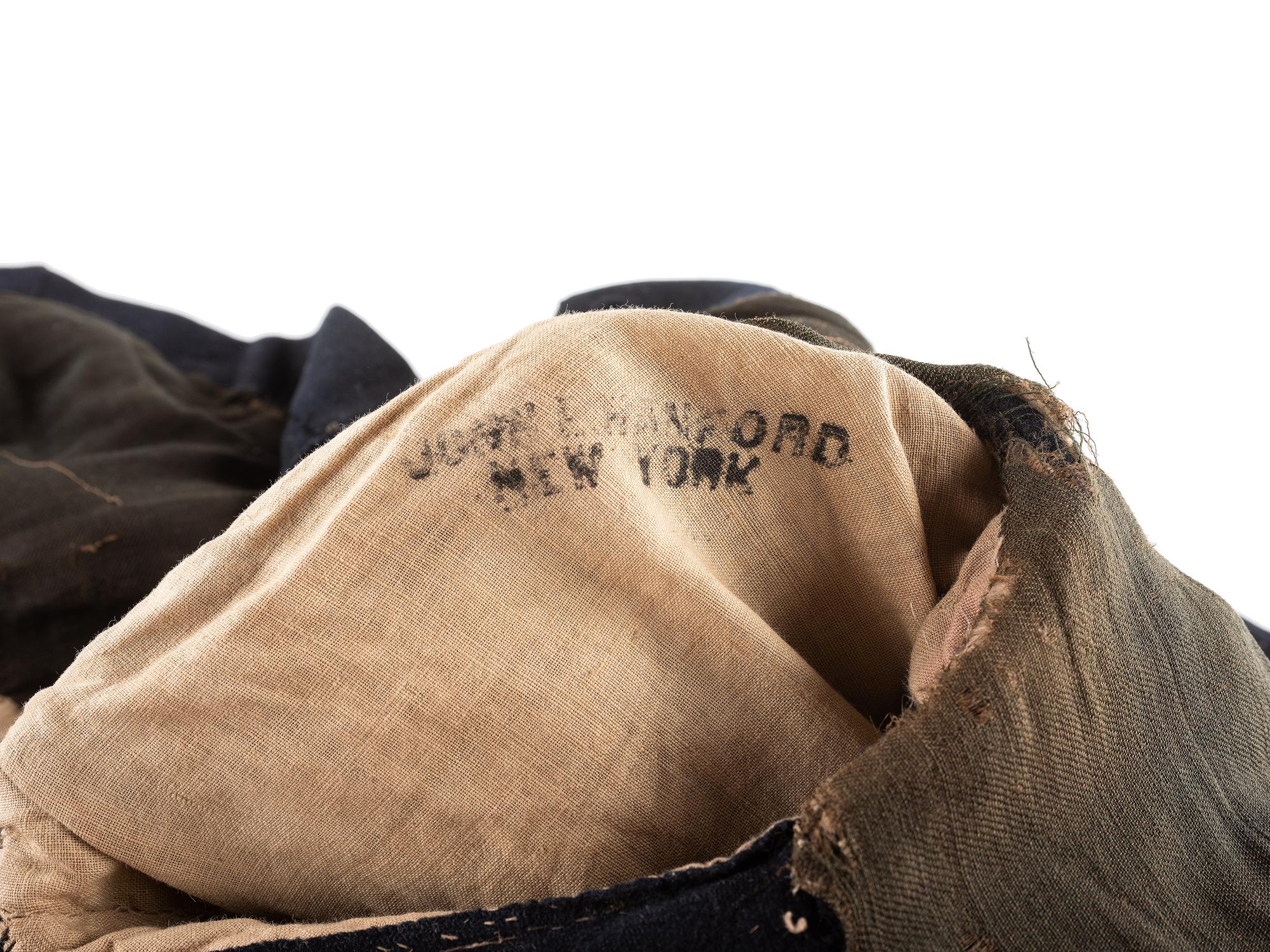 [CIVIL WAR]. A collection of items attributed to Thomas W. Johnson, Co. K, 4th Delaware Infantry, incl. frock coat, cap, belt rig, and cartridge box.