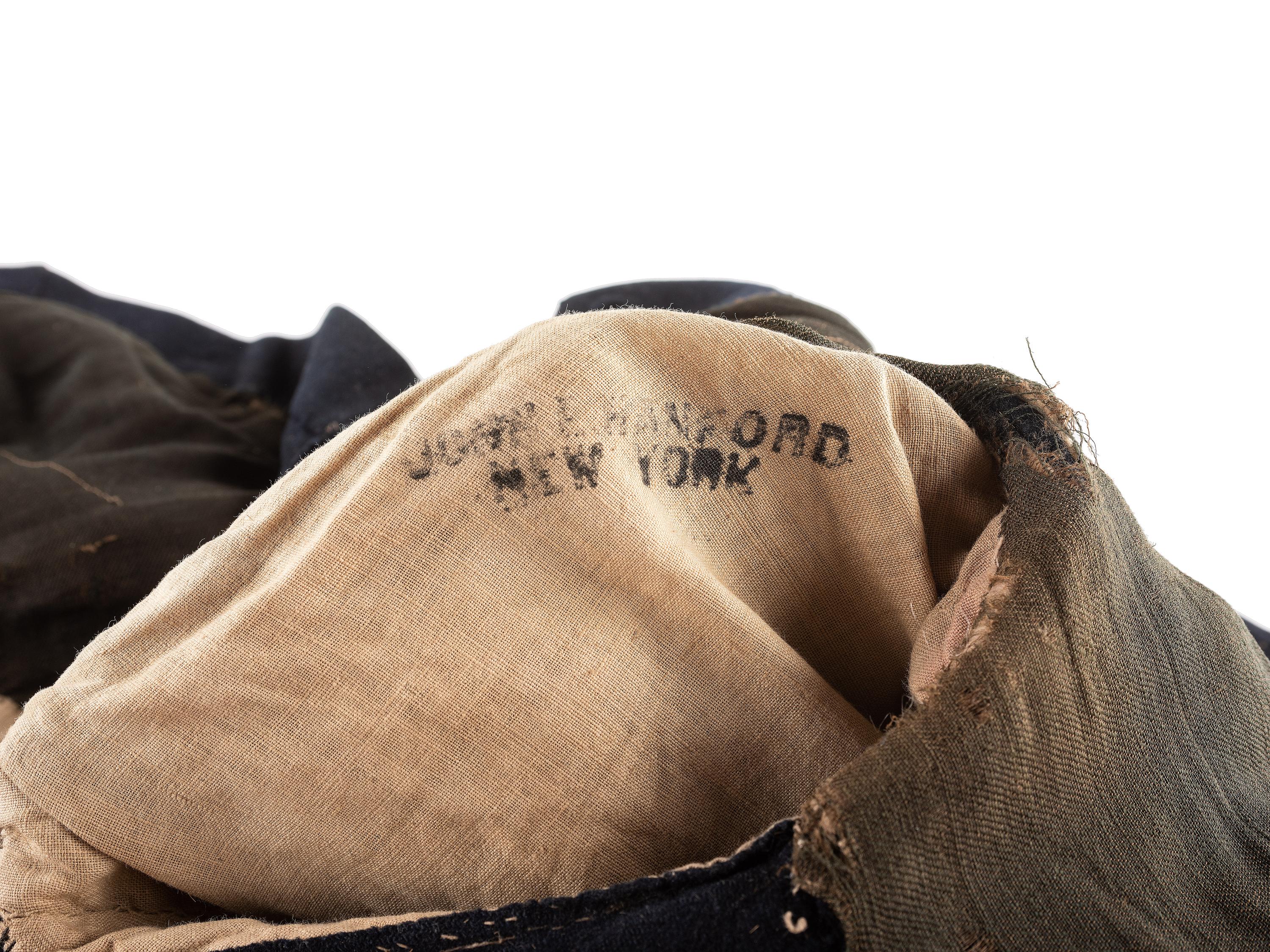 [CIVIL WAR]. A collection of items attributed to Thomas W. Johnson, Co. K, 4th Delaware Infantry, incl. frock coat, cap, belt rig, and cartridge box.