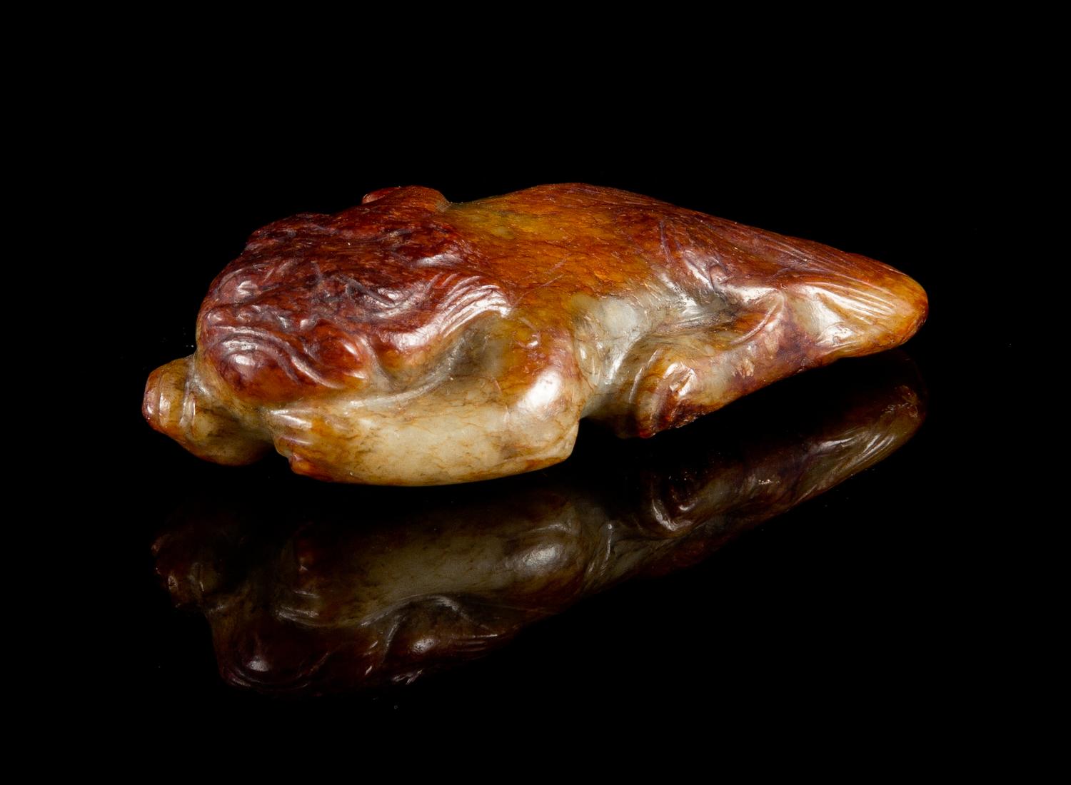 A Celadon and Russet Jade Figure of a Pixiu Length 3 1/2 inches.