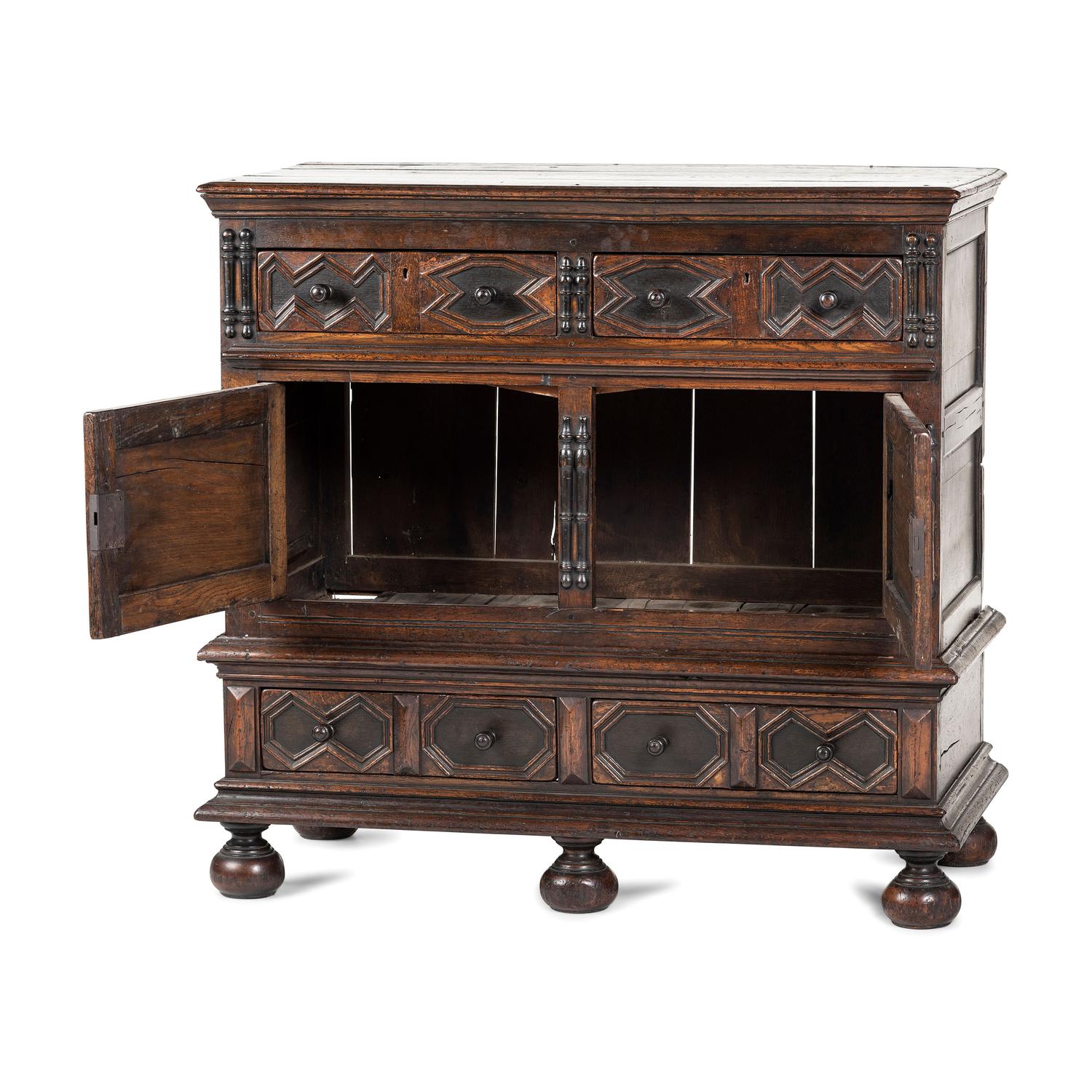 A Flemish Paneled and Molded Oak Chest of Drawers