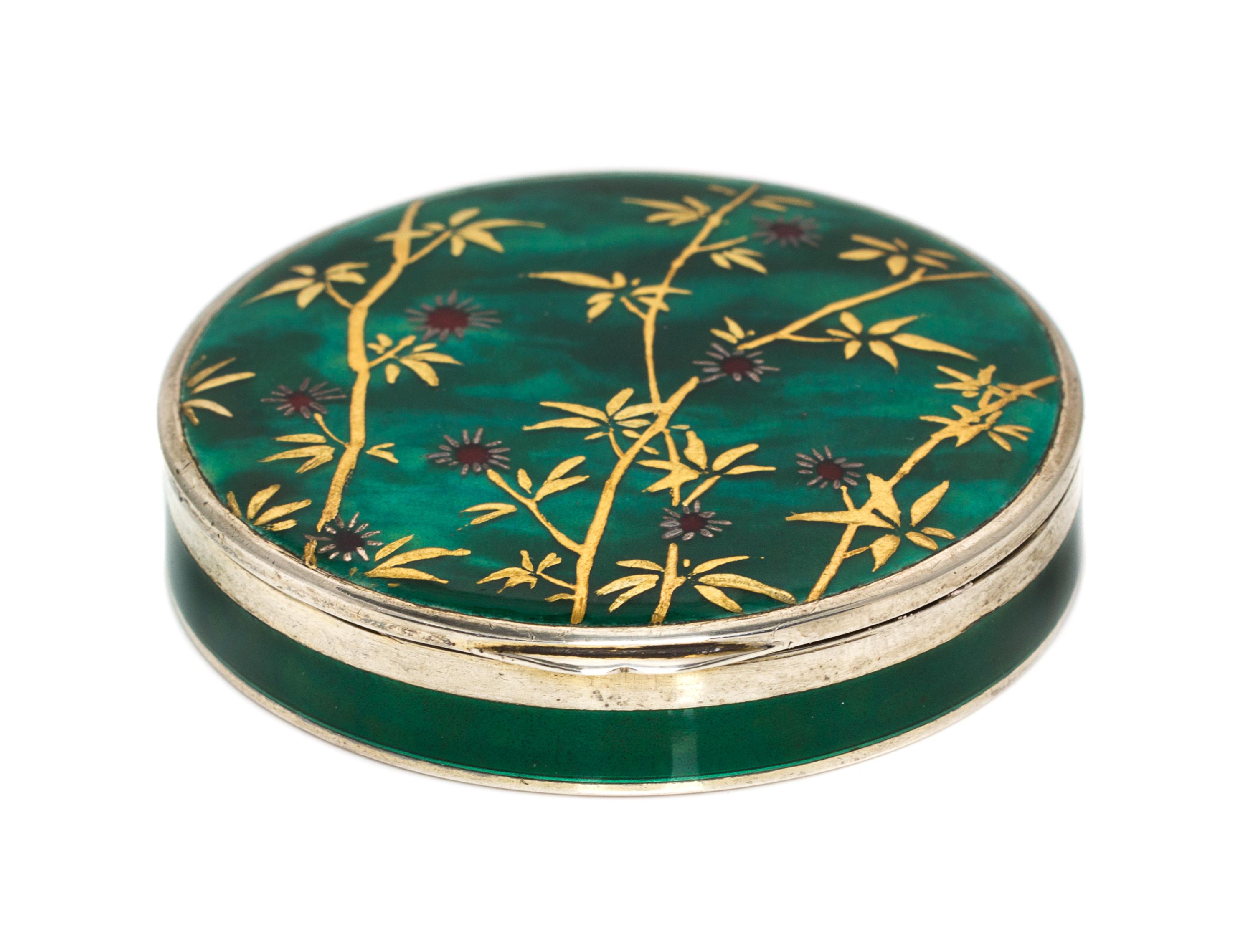 A Continental Silver and Enamel Compact, Import Mark C&C, London, 1925, of circular form, the lid with gilt and red foliate elements on