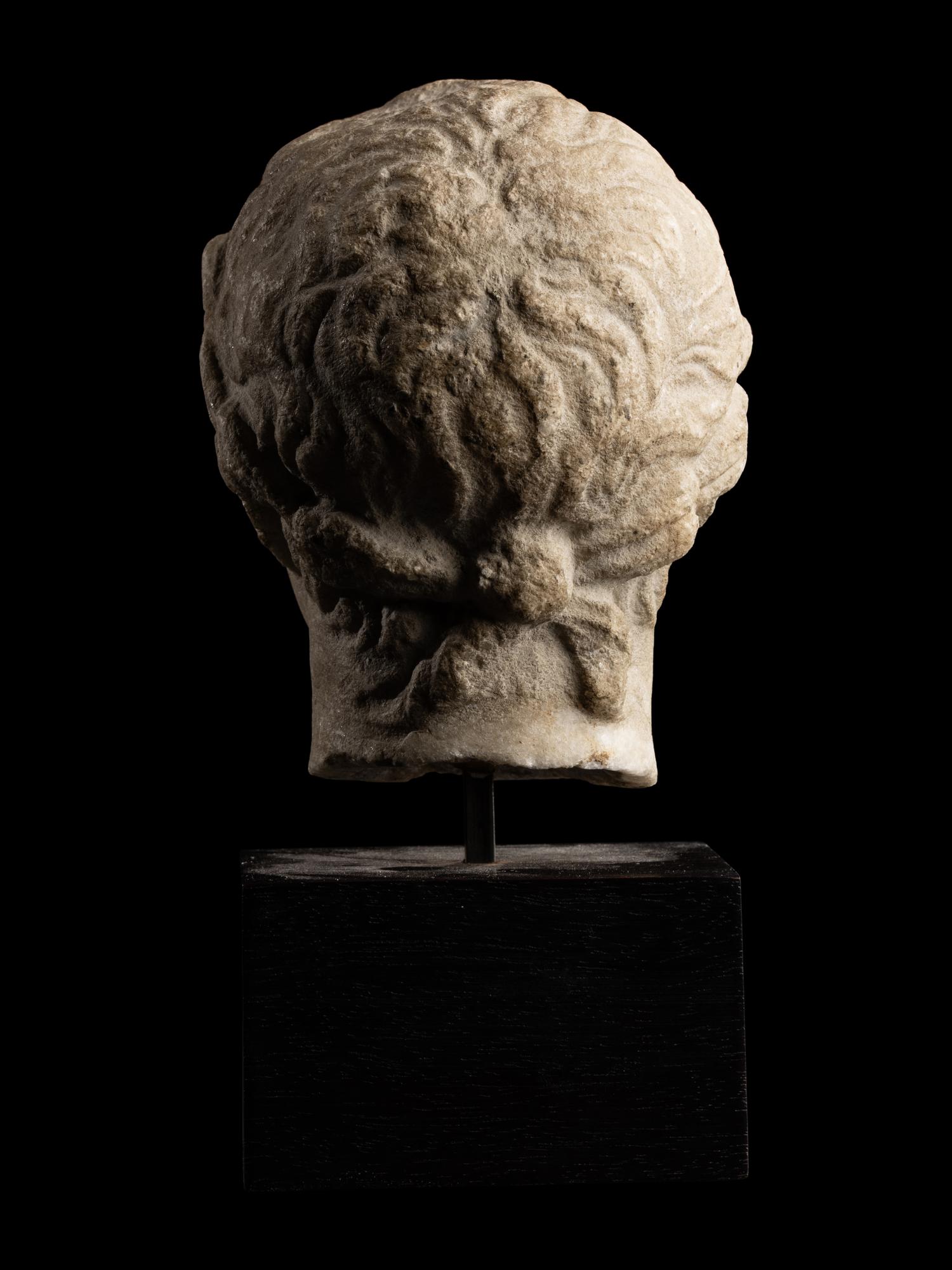 A Roman Marble Head of a Youth with Laurel Wreath